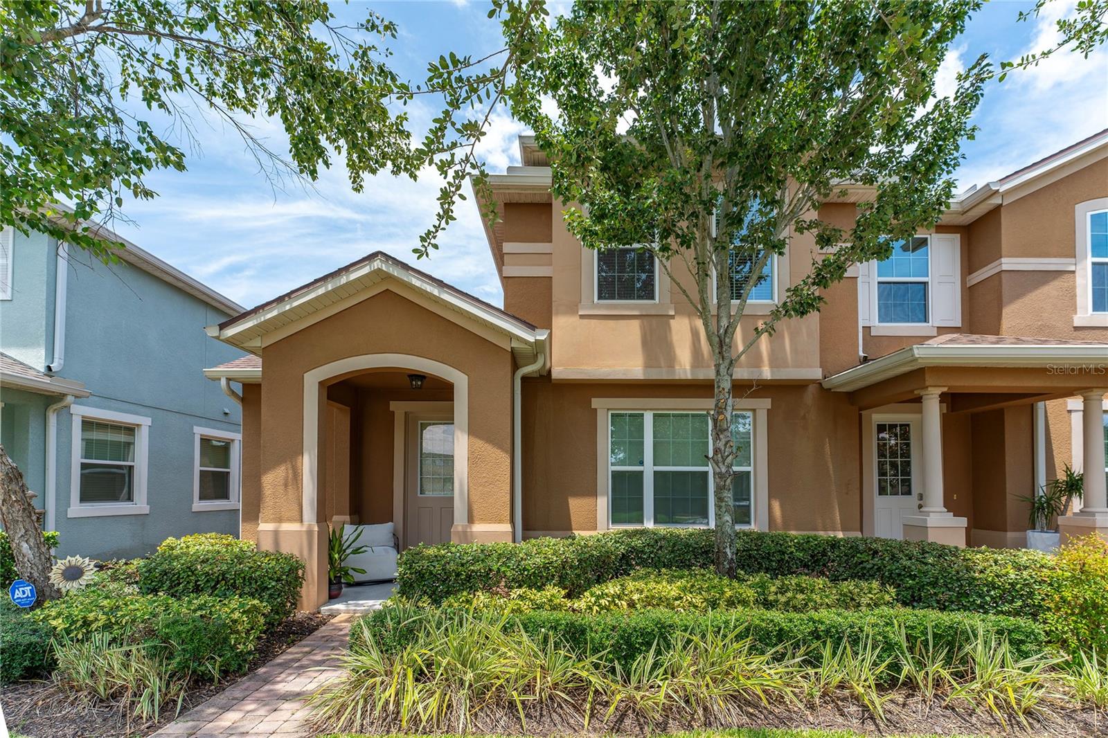 This spacious 3-bedroom, 2.5-bath townhome offers a perfect blend of comfort and convenience in a highly desirable location. Nestled in the gated and guarded Tapestry community, this home boasts a welcoming front porch that leads into a light-filled living room, with a seamless flow that extends all the way to the private patio in the back. The corner lot location ensures abundant natural light throughout the home, making it feel even more open . Downstairs, you'll find a generously sized family room, a primary bedroom suite featuring a walk-in closet. The well-equipped kitchen has granite counters, a high breakfast bar, a stylish tile backsplash, The two-car garage offers plenty of storage space, and the laundry room is conveniently located on the first floor. Upstairs, a spacious loft awaits, ideal for a home office, play area, or additional lounge space. Two secondary bedrooms share a full bath, providing ample privacy and comfort for family members or guests. Tapestry is not only a secure and well-maintained community but also offers resort-style amenities, including a community pool, clubhouse, fitness center, and more. Located just minutes from Orlando’s famous theme parks, The Loop shopping center, Orlando International Airport, and major highways, this home is perfectly situated for easy access to everything Central Florida has to offer. Live the Florida lifestyle with convenience and style in this wonderful townhome. Don't miss out on this opportunity!
