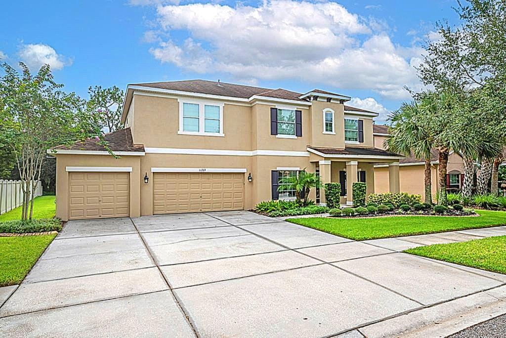 Your Search is Over! Come see this Beautiful Pool Home on Conservation in the highly rated Fishhawk School District! Lush landscape and outstanding curb appeal welcome you, Home! Boasting nearly 3600 square feet of living space with 5 bedrooms, 4.5 baths, an oversized 3 car garage, a Home Office w/ French Doors PLUS a large upstairs bonus room! Your approach is greeted by a wonderful front porch. Step inside through a handsome leaded glass door into a grand foyer flanked by a formal dining room and home office dressed in hardwood floors. As you continue through, you will find a spectacular gourmet kitchen with lots of storage in your premium/oversized cabinets, plus granite countertops, stainless appliances, pantry, breakfast nook, and pendant lighting hovering a center island. The kitchen is open to an expansive great room with tray ceilings and a picturesque backdrop of your sparkling pool, oversized private backyard and unspoiled wooded views! Your first-floor primary suite is tucked away for privacy and features private views, a tray ceiling, and a luxuriously remodeled ensuite bath with frameless glass shower, free standing tub and a magnificent custom walk in super closet! Explore upstairs to discover a spacious bonus room serving as the hub for 4 generously sized secondary bedrooms! Venture outside through a triple glass sliding door to a majestic backyard! Not only do you have a Mack daddy swimming pool / spa….but a recently upgraded Outdoor / Summer Kitchen, huge deck space dressed in travertine all under your screened lanai. Beyond the lanai is plenty of additional backyard space for the family pet and other great outdoor activities. Other Special features include: Generator Hook-up/Transfer Switch, Fresh Paint inside 2025 and outside 2021, brand new carpets, overhead storage in the garage, and more. Be sure to see the extensive list of upgrades attached. As a resident of Channing Park, you'll have access to world-class amenities, including ** TOP RATED FISHHAWK SCHOOLS, Basketball Court, Two Dog Parks, Soccer Field, Playground, Two Pools + Splash Pad, Fitness Center, Grilling Stations, Skate Park, Walking Trails, Clubhouse. This home is ready and waiting for you. Don't miss your chance to be part of one of the area’s most vibrant and welcoming communities—schedule your showing today!