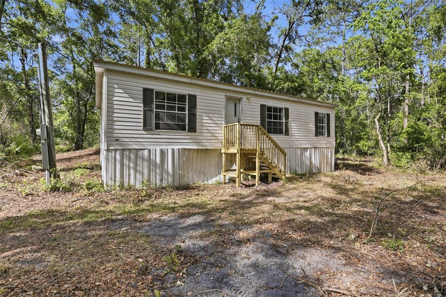 Under contract-accepting backup offers. Investor Handyman Special opportunity in Alachua County! This 3-bedroom, 2-bathroom mobile home sits on a generous 4.47-acre corner lot, offering privacy and seclusion accessed via a quiet dirt road. Built in 1996 and spanning 960 sq ft, the home features central heat and air, carpet and vinyl flooring, and an asphalt shingle roof replaced under prior ownership. Property has been cleared and is being sold as-is — ideal for a cash buyer or investor looking for land with a structure at an attractive price point. No HOA. Come see the value this acreage has!