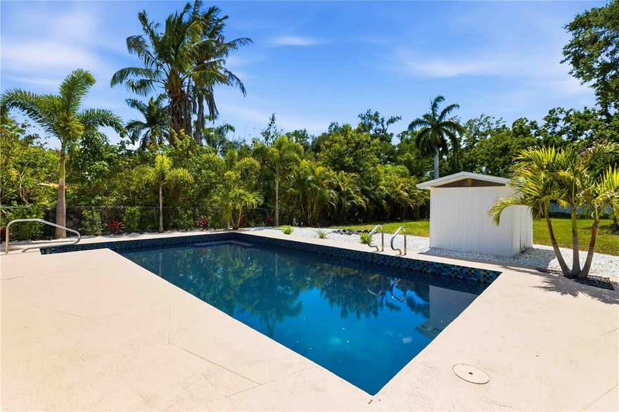 Everything has been done. You just have to show up.

This is not a partial flip or a cosmetic touch-up - 1016 71st NW in Bradenton was improved from head to toe. NEW ROOF. NEW FLOORING throughout. FULLY RENOVATED KITCHEN with white shaker cabinets, quartz countertops, a waterfall island, stainless appliances, and a deep teal tile backsplash that makes a statement. Both BATHROOMS FULLY RENOVATED with quartz vanities, large format tile, and modern fixtures. The POOL WAS RESURFACED AND RETILED. New fence. New sod. New landscaping. New paver driveway - and it's a long one.

What you can't redo is the lot. A HALF ACRE in Bradenton is hard to find at any price. The backyard is private, lush, and large - palm trees, a pool with no cage so you keep the full sky view, a pool storage shed, a separate utility shed, and still room to breathe. The Florida room brings the outside in with wall-to-wall windows and direct pool views.

NO HOA. That means you can put this on Airbnb or VRBO the week you close. Thirteen minutes to Anna Maria Island. Biking distance to an elementary and middle school. This works as a full-time family home, a rental investment, or a low-maintenance Florida base for someone who wants land without neighbors on top of them.

Split floor plan. Open concept. Oversized 1-car garage with washer and dryer hookup.
