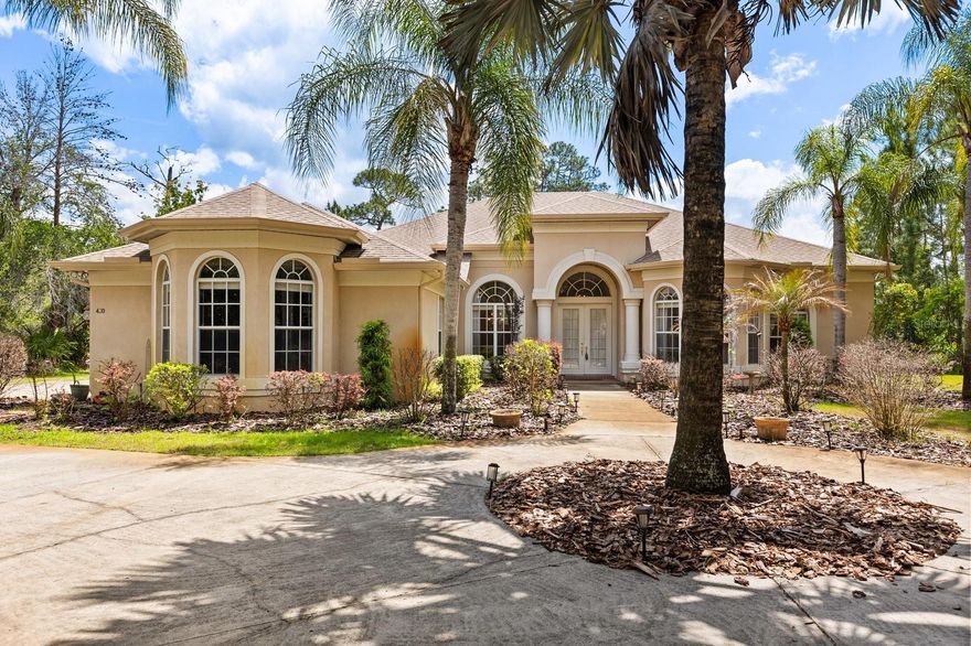 Welcome to Seminole Woods and to the architecturally intriguing design of this Arthur Rutenberg built home on five wooded acres with over   200 feet of frontage on a private picturesque pond. This spacious single-story home offers four well placed bedrooms, a front-of-the-home office, and a large DR, LR, Kitchen and Family room. As you approach this home for the first time you're struck by the two Tuscan influenced pillars, the high arches over the windows and front entry, and the two wide bay windows on either side of the pillars. The custom designed features continue as you discover the interior: please notice among the many designer upgrades the high recessed tray ceilings, again the Tuscan pillars, the rich crown molding throughout, the wall niches and built-in shelves. From the living room, breakfast nook, kitchen and family room you can enjoy the panoramic view of the pool, and beyond it, down the hill, the private nature-framed pond. The screen enclosed infinity edged pool has a fountain and a heated in-ground spa and is surrounded by genuine fieldstone decking. For your peace of mind, the roof was new in November, 2021; the two air conditioners new in 2020 & 2024; the Generac whole-house generator in May, 2025; the pool heater and pool pump in 2020 & 2022 respectively; and the pool and decking were serviced and leak checked early this year. Seminole Woods is an equestrian community and a nature lover' s dream. Amenities include miles of trails for horses and hikers, and a gated park on full-use skiable Buck Lake with a dock and boat launch, a picnic pavilion, sports courts and playground.