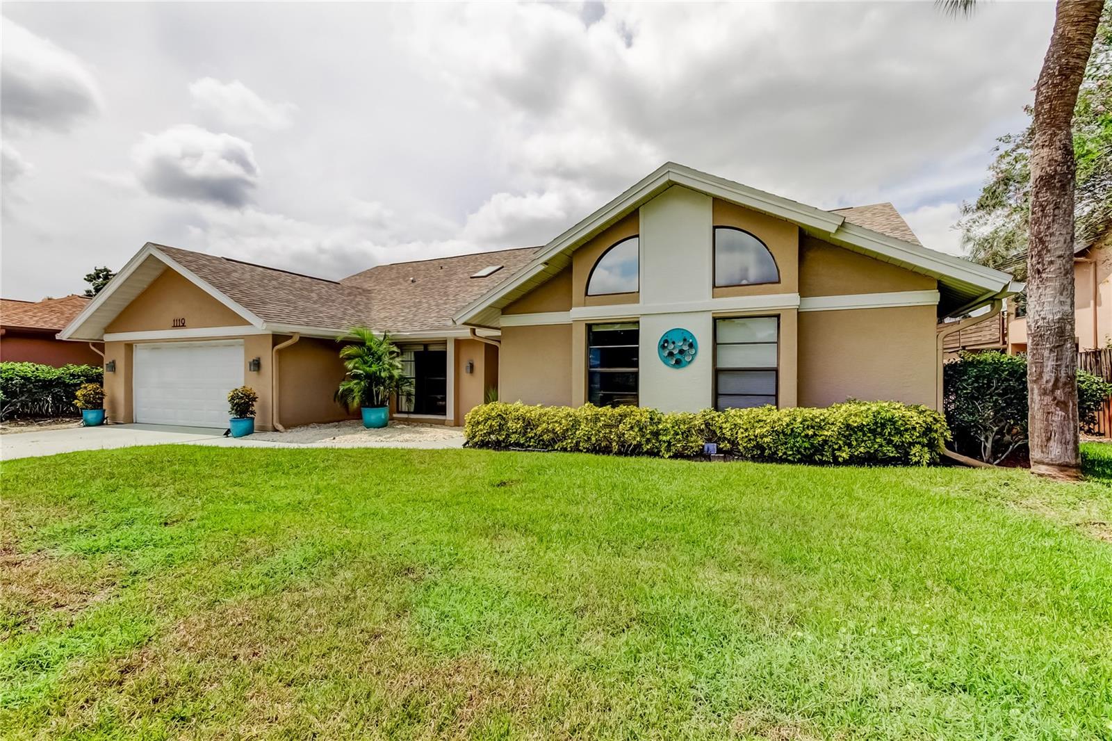 Welcome to this beautifully maintained 4 bedroom, 2.5 bath home with an office/nursery in the highly desirable golf cart friendly community of Huntington Trails. One of the larger homes in the neighborhood, it features a flexible split-bedroom layout with expansive, light-filled living areas and thoughtful updates throughout. The spacious great room with soaring ceilings, skylights and large wood burning fireplace flows seamlessly into the dining area and built-in bar with wine refrigerator, creating the ultimate setting for entertaining. The updated kitchen is designed for both style and function, offering sleek cabinetry, quartz countertops, gas stove, and two pantries. An adjoining eat-in space opens through French doors to the screened patio and includes additional cabinets and countertop space—perfect for a coffee bar or serving station. Three independent AC systems, the largest one installed 2025, provide year-round efficiency and comfort. All bathrooms have been beautifully updated. The primary suite easily accommodates large furnishings and boasts a walk-in closet with custom built-ins, along with a spa-like en suite bath featuring double sinks, jetted tub, and walk-in shower. A flexible office/nursery is located off the primary suite, providing privacy and convenience. The oversized third bedroom with walk-in closet and adjoining bath with a large walk-in shower makes an ideal teen or in-law suite. A versatile bonus room off the great room can serve as a library, media lounge, or playroom. Outdoor living shines with both a screened patio and an open-air patio for dining or relaxation. The yard is low-maintenance and fully fenced on three sides, offering both privacy and peace of mind. Additional features include a tankless water heater, water softener, hurricane garage door and newer roof (2018) for peace of mind. Just minutes from Main Street Safety Harbor, you can walk, bike, or ride your golf cart to shops, restaurants, waterfront parks, and lively festivals. Marshall Street Park—with trails, tennis, pickleball, and a playground—is a short walk away, while Tampa International Airport, Clearwater Beach, and Honeymoon Island are all easily accessible