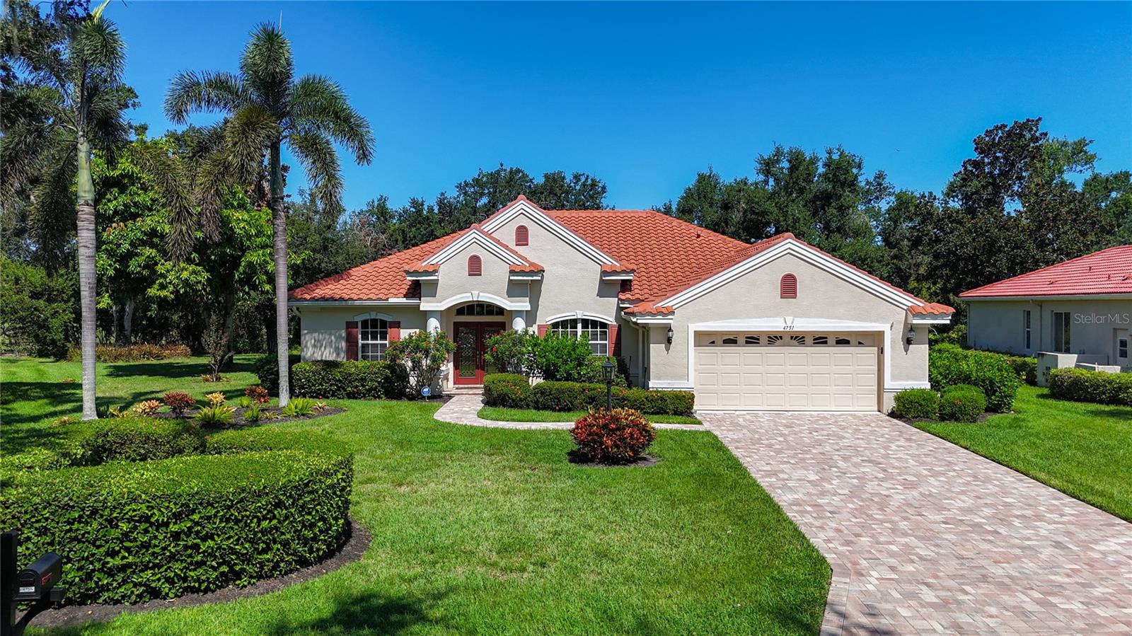 Tucked away in the gated community of Treymore at the Villages of Palm Aire, this Arthur Rutenberg-designed home for sale sits gracefully on an oversized 0.37-acre lot, offering a blend of privacy, comfort, and thoughtful design. The glass front entry double doors, brick pavered walkway and lanai added in 2023 lead you to an open floor plan. New luxury vinyl plank flooring (2023) flows seamlessly throughout, with the exception of the tiled primary bath. At the heart of the home is a spacious great room with vaulted ceiling and sliding glass doors that open to a generous screened lanai. Here, a solar paneled (2022) pool and retractable awning create an ideal space for both entertaining and quiet mornings with coffee. The kitchen, designed for both functionality and style with staggered cabinets, features a gas range, double oven, tile backsplash, and pendant lighting over the breakfast bar. Three cabinets offer convenient roll-out shelving, perfect for keeping things organized. The primary suite is a peaceful retreat, with two large walk-in closets and a spa-like ensuite bathroom featuring dual vanities, a walk-in shower, a garden tub, and private water closet. Two additional bedrooms are positioned on the opposite side of the home, creating a perfect split plan for guests or family. This home has been lovingly maintained with a new washer, dryer, and refrigerator (2025), a new gas water heater coming September 2025, a tile roof replaced in 2021, and an A/C system updated in 2019—with ducts cleaned and a UV light added in 2025. For peace of mind and added convenience, the home also includes Mylar film on all windows and sliders, a portable gas generator, and an electric vehicle charger in the garage. Located just minutes from the UTC Mall, SRQ Airport, and the cultural hubs of Sarasota and Bradenton, you’re also within 14 miles of some of Florida’s most celebrated beaches—Siesta, Lido, and Bradenton. For those who enjoy an active lifestyle, optional membership at the Palm Aire Golf & Country Club opens the door to golf, tennis, pickleball, a fitness center, and fine dining.