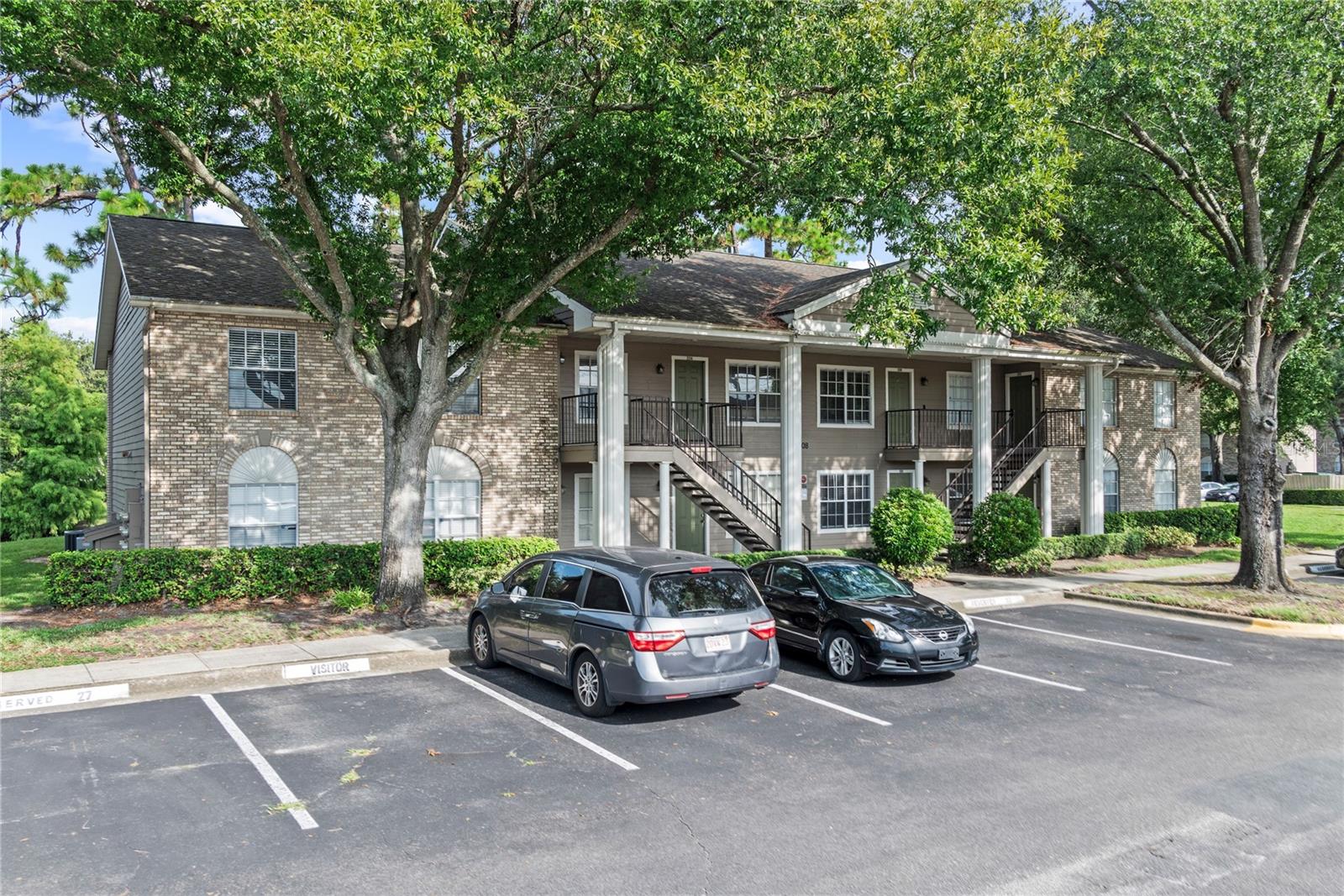 One or more photo(s) has been virtually staged. Welcome Home! Move-in-ready fully renovated first-floor condo in sought-after resort-like community, 1 mile from UCF! This beautifully updated 2-bedroom, 2-bathroom unit is just minutes from Oviedo on the Park, Research Park, and Waterford Lakes. From the moment you walk in, you’ll love the fresh, modern feel created by the contemporary finishes, durable wood-look tile flooring, and thoughtful open layout. The kitchen has been completely updated with sleek cabinetry, granite countertops, and brand new stainless steel appliances, making it both functional and stylish for everyday cooking or entertaining friends. You’ll also appreciate the peace of mind that comes with brand-new plumbing, a new HVAC system, and a new water heater throughout the unit. The primary bedroom is tucked privately at the back of the condo, complete with an updated en-suite bathroom and plenty of closet space. The second bedroom is located conveniently near the guest bath and laundry closet. One of the standout features of this condo is the private screened-in porch overlooking a peaceful pond. Perfect for enjoying your morning coffee or winding down at the end of the day. And with first-floor access, there’s no need to worry about hauling furniture or groceries up stairs. The community itself offers a resort-like feel, with amenities including a pool, clubhouse, tennis courts, and basketball courts. Your assigned parking spot directly in front of the unit and plenty of guest parking make life even easier, and the condo fee conveniently covers water, sewer, and garbage services. If you’ve been searching for a move-in ready condo with modern touches and a relaxing pond view, this one is truly a rare find. Schedule your private showing today and see why this unit stands out from the rest!