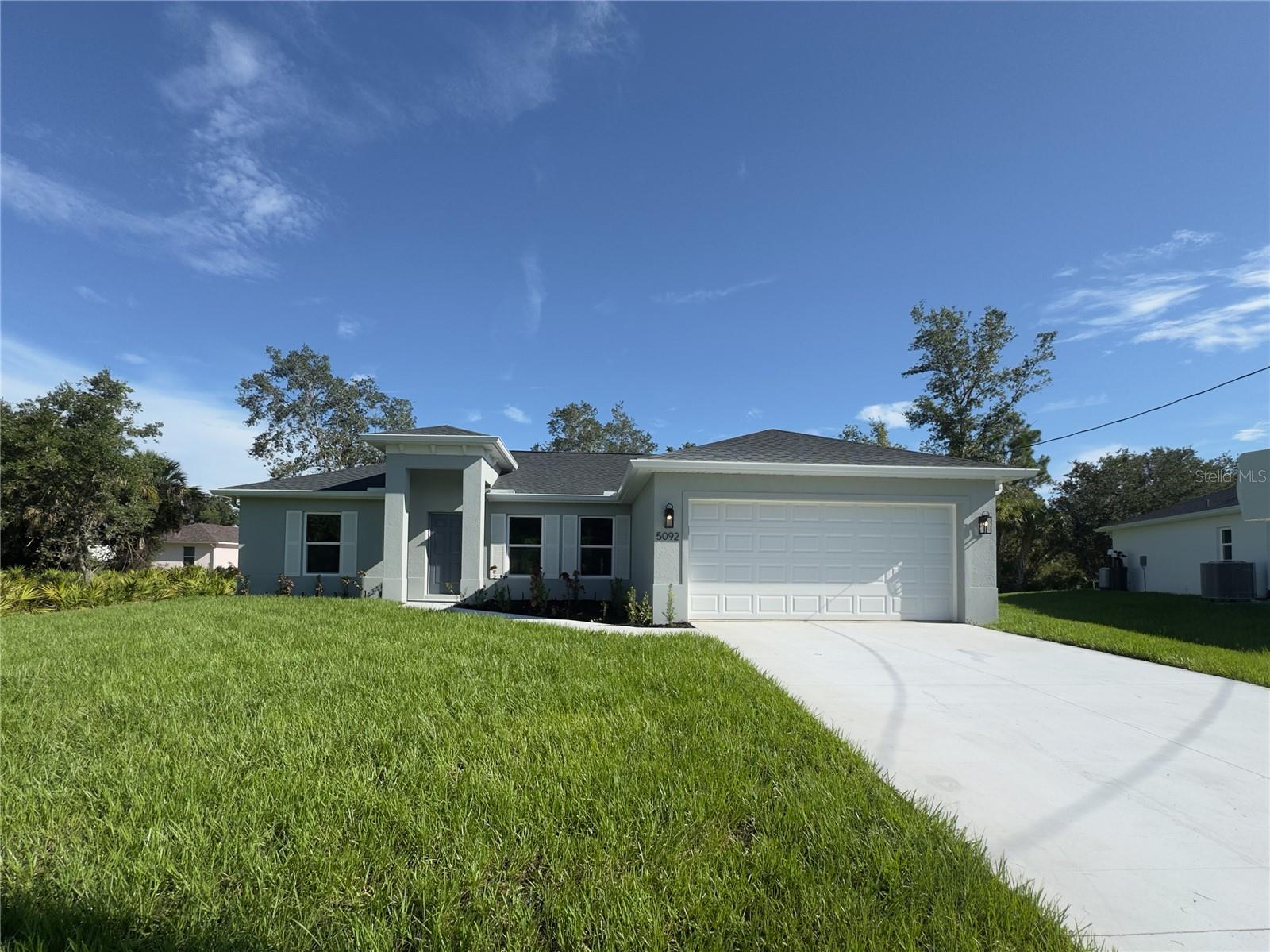 One or more photo(s) has been virtually staged. Beautiful New Construction Home Available Now on an Oversized Lot! Everything is Included and Everything is Upgraded! Starting with an open, split floor plan with vaulted ceilings, this home has Hurricane Impact, insulated, low e windows, full overlay cabinets, stainless steel kitchen appliances, quality stone countertops and window sills, porcelain tile throughout, 30-year shingles, 3 zone sprinkler system, screened lanai, brand name plumbing and electrical fixtures, fully sodded and landscaped. This home has been built to keep insurance, maintenance and utility costs low. Preferred lender is offering up to $1,500 in closing cost assistance! Take a tour through of one of our Beautiful Homes: https://youtu.be/SFsL-Aell24