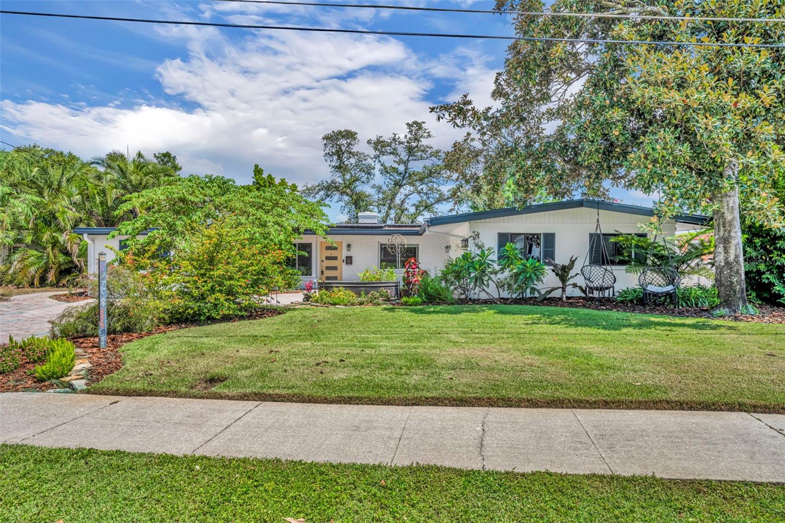 One or more photo(s) has been virtually staged. Welcome to this charmer in one of Orlando’s most beloved neighborhoods; Audubon Park! This beautifully updated one-story home offers 4 spacious bedrooms, 3 bathrooms, and a rare combination of comfort, style, and location. Located on Lake CayDee, this property invites you to soak in the beautiful lake views every day you live there. Step inside to find an open and inviting floor plan filled with natural light, ideal for both relaxed living and entertaining guests. The layout flows effortlessly from the spacious living area to a modern kitchen with updated finishes, all looking out over the water and pool area. Enjoy a large primary bedroom and primary bathroom suite that feels more like a resort style spa than a traditional bathroom. Outside the backyard is a showstopper. Landscaped with mature tropical foliage, a sparkling pool heated by solar panels, with additional solar panels providing electricity for the home, and a patio designed for year-round enjoyment. Whether you're hosting a sunset dinner party or simply soaking in the view with your morning coffee, this setting is pure Florida magic. With tons of space inside, and a rare 2 car garage with EV charging capability, this house has features that you won't find in other homes. Located within minutes of the highly rated Audubon Park K-8 School; which is consistently ranked among the top schools in Orlando, this home is perfect for someone who values education and community. Just minutes from the East End Market, Leu Gardens, and the shops and restaurants of the Audubon Park Garden District, you’ll enjoy a walkable, bike-friendly lifestyle in a neighborhood known for its charm, culture, and creative energy. Don’t miss this rare opportunity to own a piece of lakefront tranquility in one of Orlando’s most desirable and vibrant neighborhoods. Schedule your private tour today!