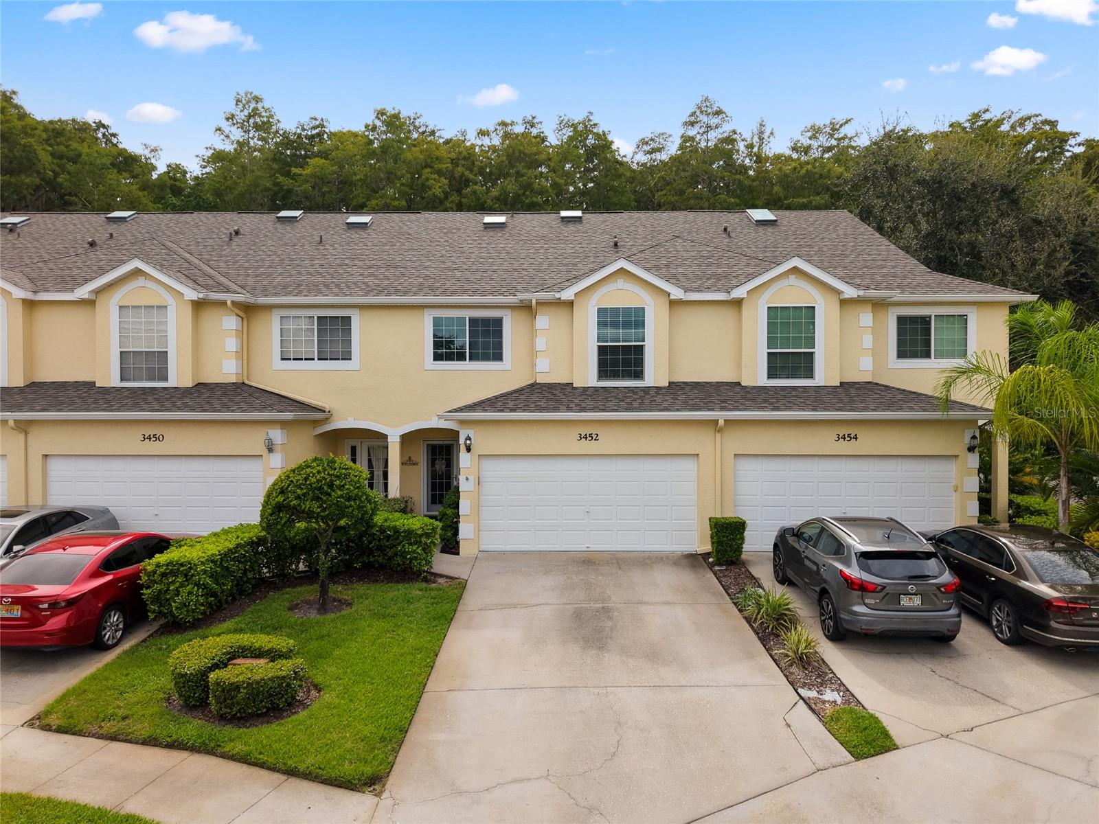 Welcome to Ashley Downs! Located in a secure, gated community, this beautifully maintained 3-bedroom townhouse with an additional office/den offers comfort, style, and modern upgrades throughout.
Step inside to an open layout featuring an updated kitchen with granite countertops, stainless steel appliances, a center island with sink and storage, and solid wood cabinetry with under-cabinet lighting. Gorgeous hardwood floors flow through the living and dining areas, complemented by a cozy built-in electric fireplace. Additional under-stair storage makes smart use of space. Plush, thick-padded carpet provides comfort in the bedrooms and stairs.
The spacious owner’s suite includes dual closets, granite countertops, a walk-in shower, soaking tub, and access to a private screened-in patio. Two additional east-facing bedrooms—share a full bath with a tub.
This home is move-in ready with major updates already completed: roof (2021), high-efficiency 18 SEER Trane HVAC (2010), water heater (2017), updated windows, new appliances and a Ring doorbell system. The 2-car garage features a protective floor coating, overhead storage, and a modular shelving system for maximum efficiency.
Community highlights:
Ashley Downs offers a low monthly fee, is pet-friendly (pets under 25 lbs), and includes a sparkling pool with gazebo, additional guest parking, and a welcoming atmosphere. Ideally situated near top-rated schools, the renowned Innisbrook Golf Course, and just a short drive to beaches and parks, this location balances convenience with lifestyle.