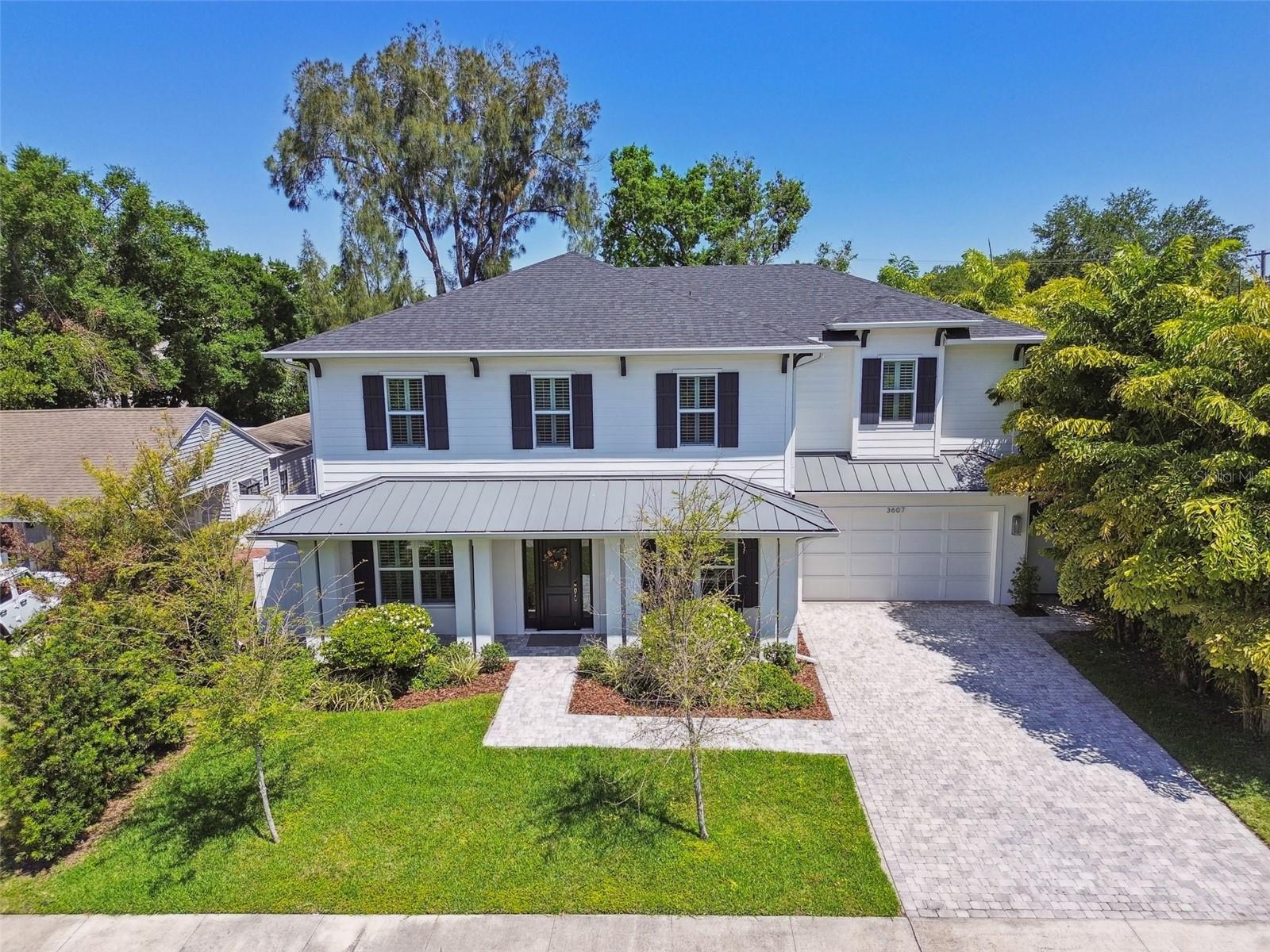 **Featured as the "inspiration home" on an upcoming episode of HGTV's 100 Day Dream Home** Welcome to this gorgeous Key West style POOL home in South Tampa! The quiet tree-lined neighborhood of Bon Air is centrally located in the coveted A-rated Plant district - and NOT IN A FLOOD ZONE! Exceptionally designed and meticulously constructed, this stunning home features 5 bedrooms, 4 full bathrooms, an oversized 2 car garage, and heated pool and spa in its private backyard oasis. The 1st floor bedroom with adjoining full bathroom makes an excellent home office or a guest suite. The spacious layout is perfect for entertaining and thoughtfully laid out with a truly functional floorplan. The heart of the home naturally is the kitchen, and it is fully equipped and ready for hosting, with a large center island & touchless faucet, solid wood soft-close cabinets up to the ceiling, coffee bar, built-in stainless steel Viking appliances including gas cooktop, pot filler, a wet bar leading to the dining room, and a full walk-in pantry. Upstairs you will find a loft and wet bar, lots of storage, and a generously sized laundry room with utility sink and gas dryer connection. Two guest bedrooms share a full bathroom with double sinks, while a separate bedroom has its own private en-suite bathroom and walk-in closet. Double doors lead to a grand primary suite with 2 walk-in closets, luxurious primary bathroom with dual vanities, free-standing tub, and glass enclosed shower with body sprays. No detail was overlooked with 10’ ceilings throughout the entire home and 8’ doors, including the 3-panel sliding glass door that opens to the lanai - bringing the outdoors in with a full outdoor kitchen and retractable, remote-controlled screen. The pool is a true retreat with a spacious sun shelf, deck jets, customizable color-changing underwater LED lighting, and beautiful custom copper gas fire bowl aside the relaxing spa. The smart home features are taken to the next level with an impressive Brilliant Tech home automation system – controlling everything from lights and dimmers (and programmable “scenes”!), outlets, sound systems and AV, the Nest thermostat, security system, front door lock and more! The keyless front door entry has a retractable front door screen door with a durable pet screen, and the MyQ smart garage system allows for secured deliveries while you’re away. Truly a techie’s dream, this home is also hard-wired with ethernet and 4K, with a multitude of audio and video connection points throughout the interior and exterior of the home. This is a rare find in an ultra-convenient location, close to everything S Tampa has to offer - tons of amazing restaurants, shopping, activities & entertainment - and less than 10 minutes to downtown or the airport! Call today to schedule a private showing of your new dream home!