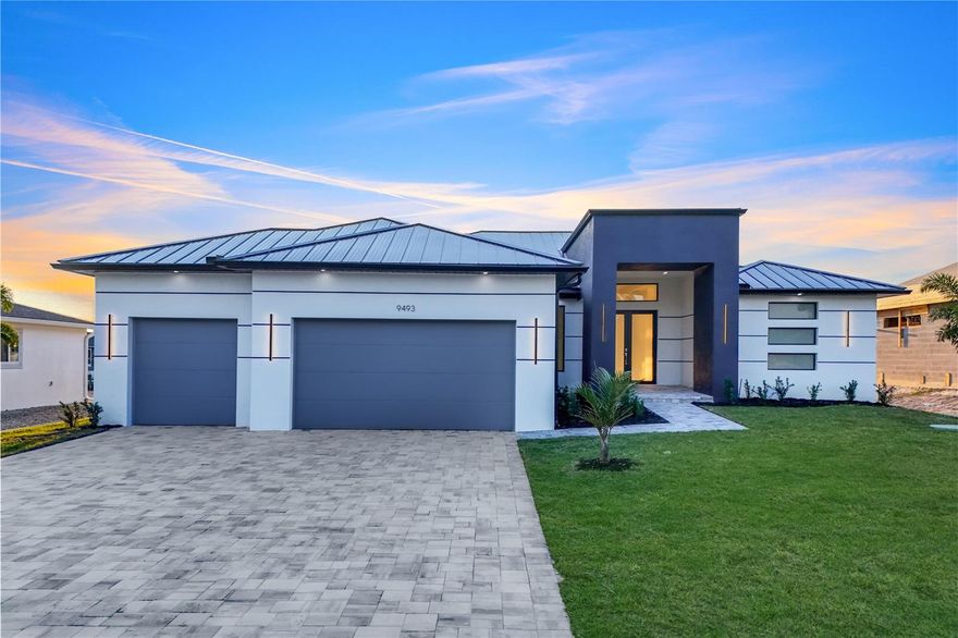 2025 NEW HOME, waiting for its first owner. Builder has spared no expense on this stunning Gulf access WATERFRONT POOL HOME. This amazing 2,446 SqFt. luxurious home, boasts 4 bedrooms, plus 1 office with glass double doors, 3 full bathrooms, and an amazing, fully equipped outdoor kitchen with all top-of-the-line appliances.
The pool overlooks the canal, where you could have your boat moored along the 80-foot seawall. Easy access to the open water and the Gulf will be a plus for every boating lover. There is plenty of space in your enclosed outdoor pool area for entertaining guests. The pool features a spa sitting area, outdoor shower, and LED pool lighting. The open floor plan offers you a majestic, luxurious space, adorned with an oversized porcelain tiled floor throughout. The Great Room features a coffered high ceiling with LED lighting, an 86-inch Samsung flat TV, and a modern electric fireplace.
LED strip lighting in the entryway for a touch of sophistication. The Kitchen is a chef's paradise with all top-of-the-line Whirlpool appliances. European-style self-closing cabinets contrast with the elegant quartz countertops. For your peace of mind, this house features a metal roof and impact windows, and doors. Looking for a perfect place to call home? This move-in-ready home awaits you in the much-desirable South Gulf Cove community.