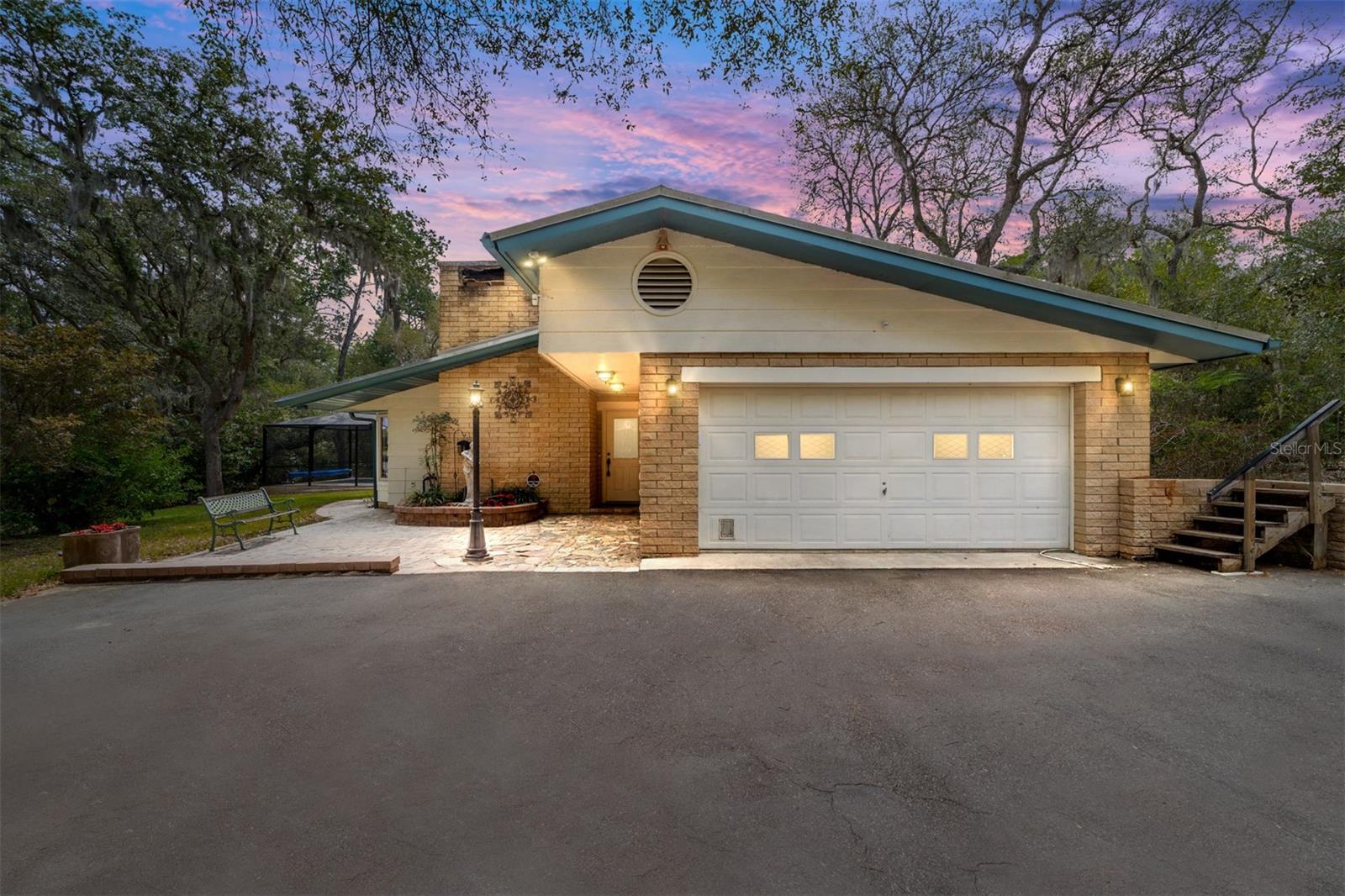 Welcome to your private slice of paradise! Nestled on the shores of a pristine spring-fed lake and surrounded by 2.72 acres of natural beauty, this charming 3-bedroom, 2-bathroom home invites you to live the lake life every day. Situated right on the fringe of the Ocala National Forest, this property offers the perfect balance of serenity, privacy, and breathtaking water views. A canopy of majestic oak trees, and several orange and citrus trees greet you upon arrival, setting a tranquil tone that continues throughout the property. Step inside and experience a home that has been thoughtfully and lovingly updated by its current owners. Major improvements include a durable metal roof (2013), a new HVAC system (2014), Pella windows for enhanced energy efficiency and natural light, a completely updated kitchen with new appliances, a new electrical panel (2014), and a 10x20 shed (2014) for extra storage. An elevation certificate is also available to assist with insurance needs — a valuable benefit for peace of mind. The great room features soaring cathedral ceilings, a cozy fireplace currently connected to a propane gas tank, which can easily be converted back to wood-burning if you prefer, and expansive windows overlooking the lake and backyard. It's the perfect space to gather, unwind, and watch the abundant birdlife and local wildlife thrive in their natural environment. The primary bedroom suite offers serene views of the pool deck and lake and features an ensuite bathroom, creating a private oasis where you can relax and recharge after a day on the water or in the pool (salt system). The layout is designed for both everyday living and unforgettable weekends, whether you're sipping coffee on the porch, kayaking across the glassy lake, or simply enjoying the peace and quiet of nature right in your own backyard. Located just minutes from Forest Corners for shopping and dining, yet worlds away from the hustle and bustle, this unique property is a rare find. Plus, with no HOA, you’ll enjoy the freedom to truly make this lakeside retreat your own. Don't miss your chance to live the ultimate lake life!