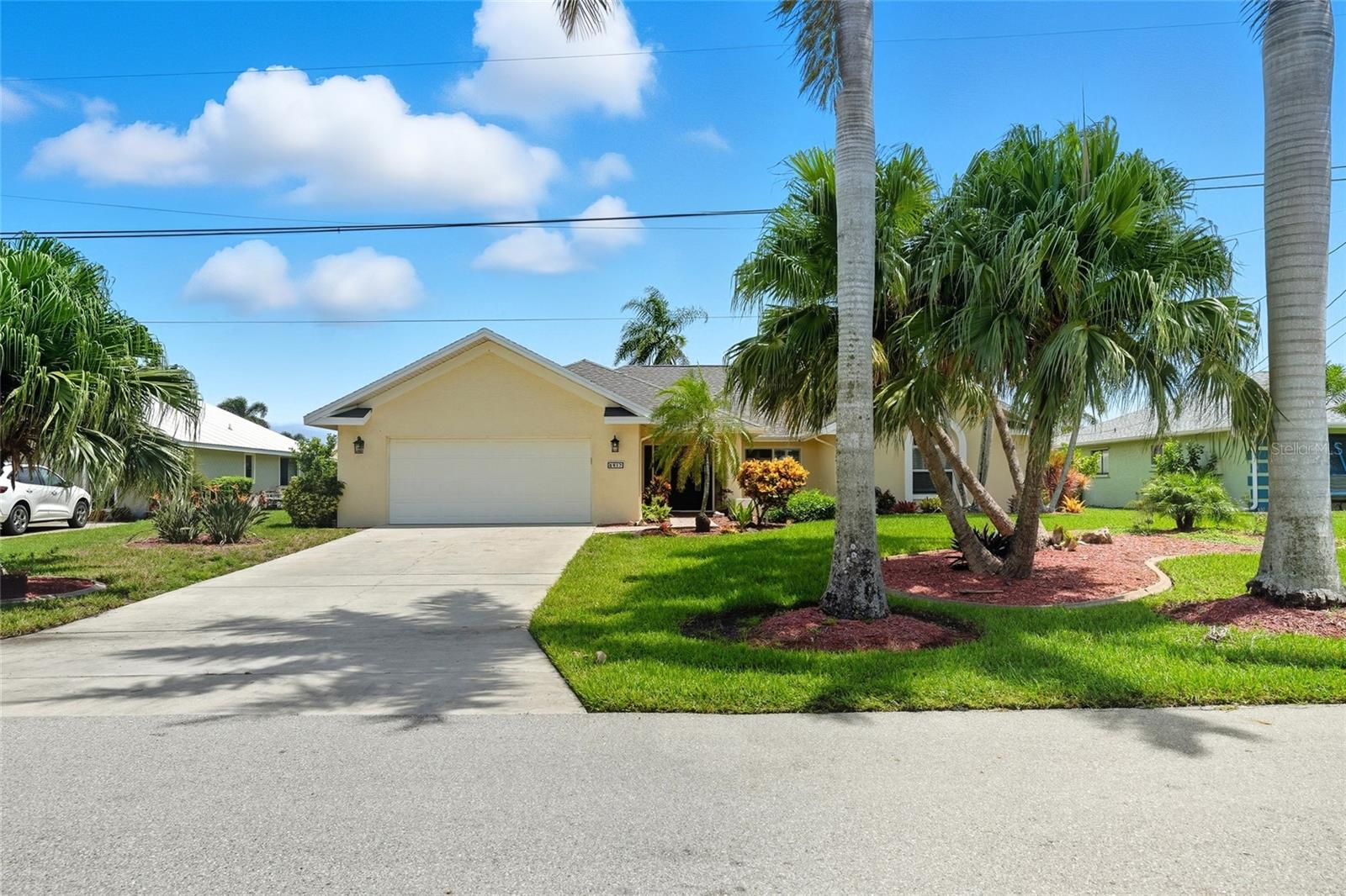 Beautifully updated 4-bedroom, 2.5-bath pool home with 2022 roof and 2024 A/C. No bridges to the Gulf and only 20 minutes to open water. Inside, an open floor plan features vaulted ceilings, a spacious living and dining area, breakfast room, and great room with sliding doors that open to the screened lanai. The kitchen offers granite countertops, stainless steel appliances, wine cooler, and breakfast bar. The split layout provides a private en suite master with direct lanai access and a bath with dual sinks. Three guest bedrooms complete the interior. Enjoy outdoor living with a heated in-ground pool, above-ground spa, built-in outdoor kitchen with gas grill, and a large covered seating area with ceiling fans. A patio, composite dock and boat lift lead directly to the canal. Located in the desirable Pelican neighborhood on a gorgeous Palm Tree lined street, this beautiful South Cape Coral home is nestled between Cape Harbor and the Westin Resort/Tarpon Point all with lots of restaurants, shopping, and just minutes to the river.