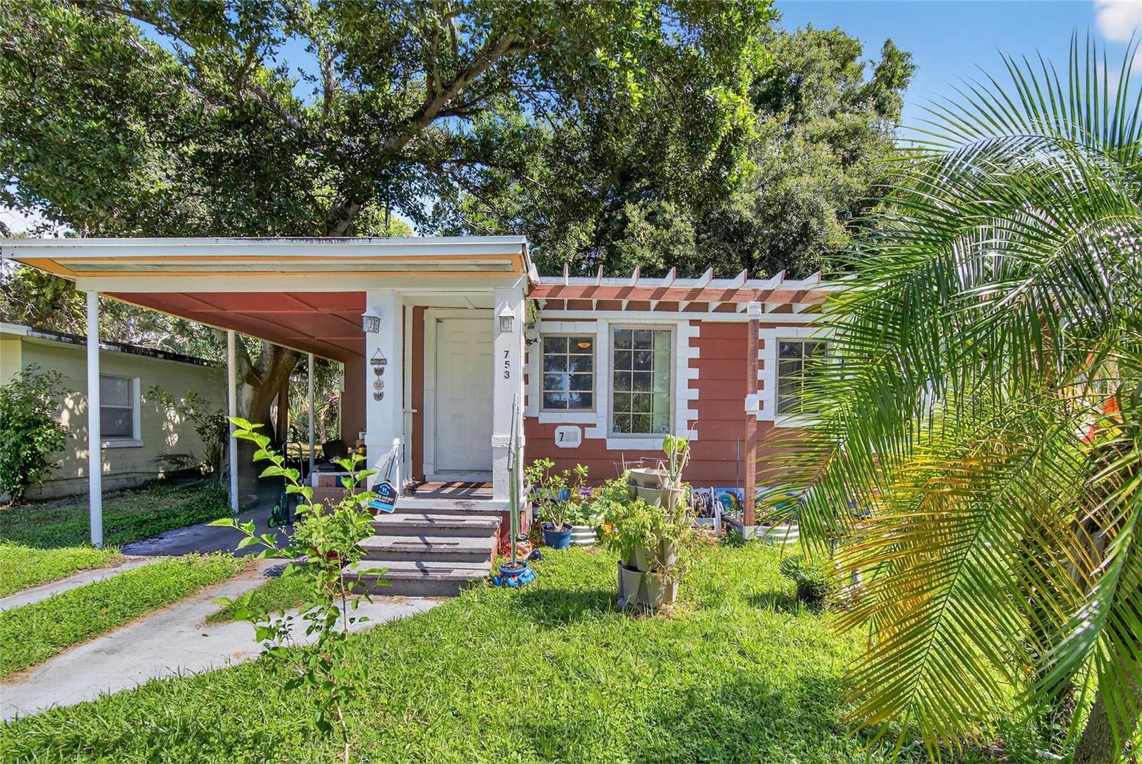 If you are looking for the perfect St. Pete home to make your own, you have found it! This home includes 2 bedrooms, 1 full bathroom, a carport for covered parking, and a roof and AC that were replaced in 2021 and 2020, respectively. You will love the oversized, fenced backyard with beautiful mature landscaping and shaded patio area, and the lush front yard complete with your own mulberry, moringa, elderberry, cranberry hibiscus, pineapple, pineapple sage, and strawberry plants. As you enter you find the living room that opens into the kitchen with direct access to the backyard. Off the kitchen is another bonus room perfect for a dining room or office. On the other side of the living room you find the 2 bedrooms and full bathroom. This home is perfect for a first time buyer ready to have their own space, an investor looking for another rental for their portfolio, or a handyperson looking to downsize with a house they can add sweat equity into. All of this is around the corner from Lake Maggiore so you can enjoy Florida nature and wildlife on walks after work. This home stayed dry during the hurricanes so you can confidently move in, enjoy weekends or sunsets at the stunning Gulf Beaches and days taking in the shops, restaurants, and charm of Downtown St. Pete within a 10 minute drive. You do not want to miss out on this one so schedule your showing today!