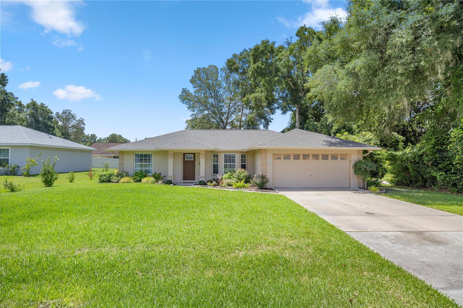 In the neighborhood of Orange Blossom Hills you can enjoy quiet living on a dead end road. You will sense the pride of ownership in this home. There are beautiful flowers and plants that create a beautiful landscape that takes you to an ample size backyard. Sleep well in this spacious 3 bedroom 2 bath home knowing you have a new roof over your head. Updated flooring and newly remodeled bathrooms with soft close doors are a bonus as well. Some features of the kitchen include brand new appliances, quartz countertops and cabinets with beautiful finishes. If you make a left out of the neighborhood you are a short drive to Ocala and make a right and you are a short drive to The Villages. No HOA or CDD. You will have access to plenty of shopping, medical, entertainment, golf, lake access, etc.