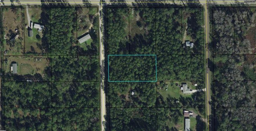 Right next to the PAVED ROAD, absolute perfect location. Not on the main road, but just one lot off! This lot is High and Dry. Bring your mobile home or manufactured home and your animals. No deed restrictions. Located in Daytona North Subdivision in Western Flagler county. This property is close to Haw Creek Preserve, Crescent Lake, Lake George, Dead Lake, 15 minutes to shopping and 30 minutes to the ocean.