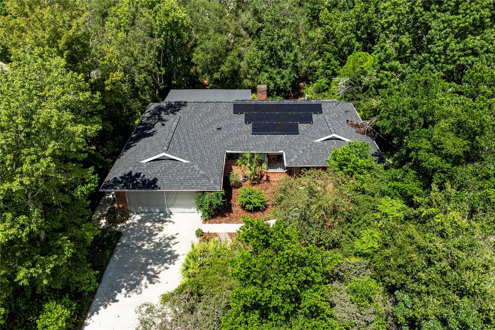 Welcome to this unique private residence surrounded by nature's embrace in the heart of Deltona! This solid brick home is enhanced by a NEW ROOF and also SOLAR panels which lead to extremely low electric bills. Within a thoughtfully designed split floor plan lies the sought after open concept. The kitchen boasts a comfortable set up including new stainless steel appliances. Within the comfort of the living room lies a real wood burning fireplace perfect for the cozy Florida winter nights. Beyond the living room, a large tiled screened in patio overlooks a beautifully oversized wooded, fully fenced, and custom landscaped back yard with brick walk ways giving 100% complete privacy! Don't miss out and come check this one out today!