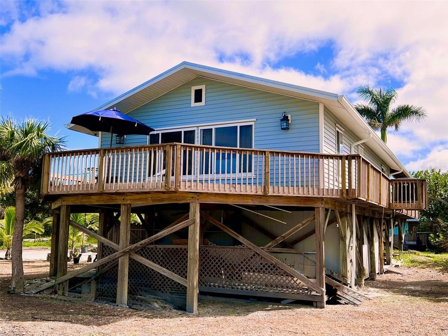 Your Beach Retreat on Little Gasparilla Island awaits you. Imagine waking up on the quiet north end of Little Gasparilla Island, where the sound of the waves and the rustle of palms replace traffic and noise. This inviting 3-bedroom, 2-bath island home sits on a spacious corner lot and gives you everything you need to step straight into the beach life. With deeded beach access just steps away and a community dock (first come, first served, just $300/year), your days can be spent on the sand, on the water, or entertaining friends on the porch. Inside, the home is open and welcoming, with a large kitchen flowing into the dining and living area, perfect for hosting family dinners or gathering with friends. The dining table seats eight, and the oversized sectional makes room for everyone after a long day of boating or beachcombing. Step outside to a breezy front porch for morning coffee, or retreat to the covered back porch where you’ll find an outdoor dining space and grill area designed for relaxed evenings. After the beach, rinse off in the outdoor shower with hot and cold water, then tuck away your gear in the ground-level storage, perfect for fishing tackle, tools, and beach toys. This home has been thoughtfully updated in the last couple of years with a new roof (2023), A/C, flooring, paint, appliances, lighting, bathroom finishes, and much more, giving you peace of mind and modern comfort from the moment you arrive. Even better, it’s being sold fully furnished and completely turn-key, all you’ll need is a toothbrush and flip-flops. If you’ve been dreaming of a place where the beach is your backyard, the neighbors wave hello, and the fishing is world-class, this Little Gasparilla escape is waiting for you. Pack your bags, your island life starts here.