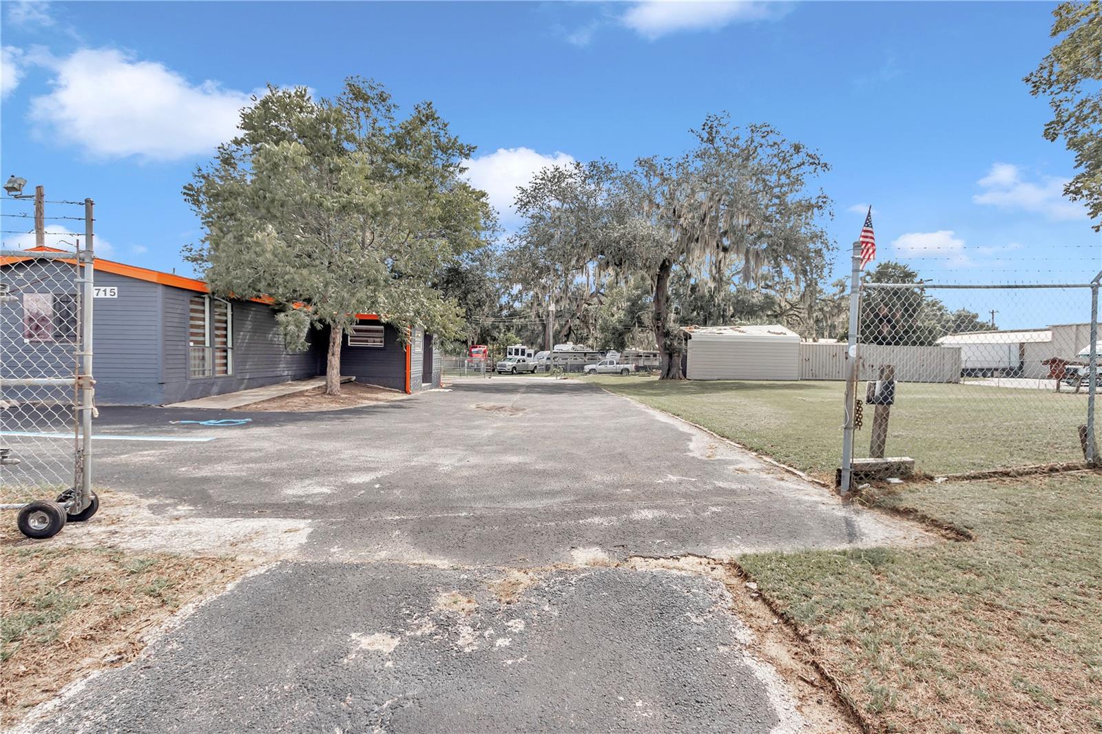 Located just minutes from downtown Ocala, this versatile commercial lot offers a range of possibilities for your business. The property is fully fenced ensuring security and privacy and features a paved parking lot for convenience. It includes a large carport and two oversized storage containers, providing ample space for storage and operations.
The renovated mobile home/office on-site boasts modern updates, including a kitchen area, vinyl wood-like flooring, beam ceilings, and a half bath. Zoned B4, this property is perfectly suited for various business applications. There's a permit in process for an auto dealership, adding potential for specific business ventures.
Don't miss out on this fantastic opportunity!