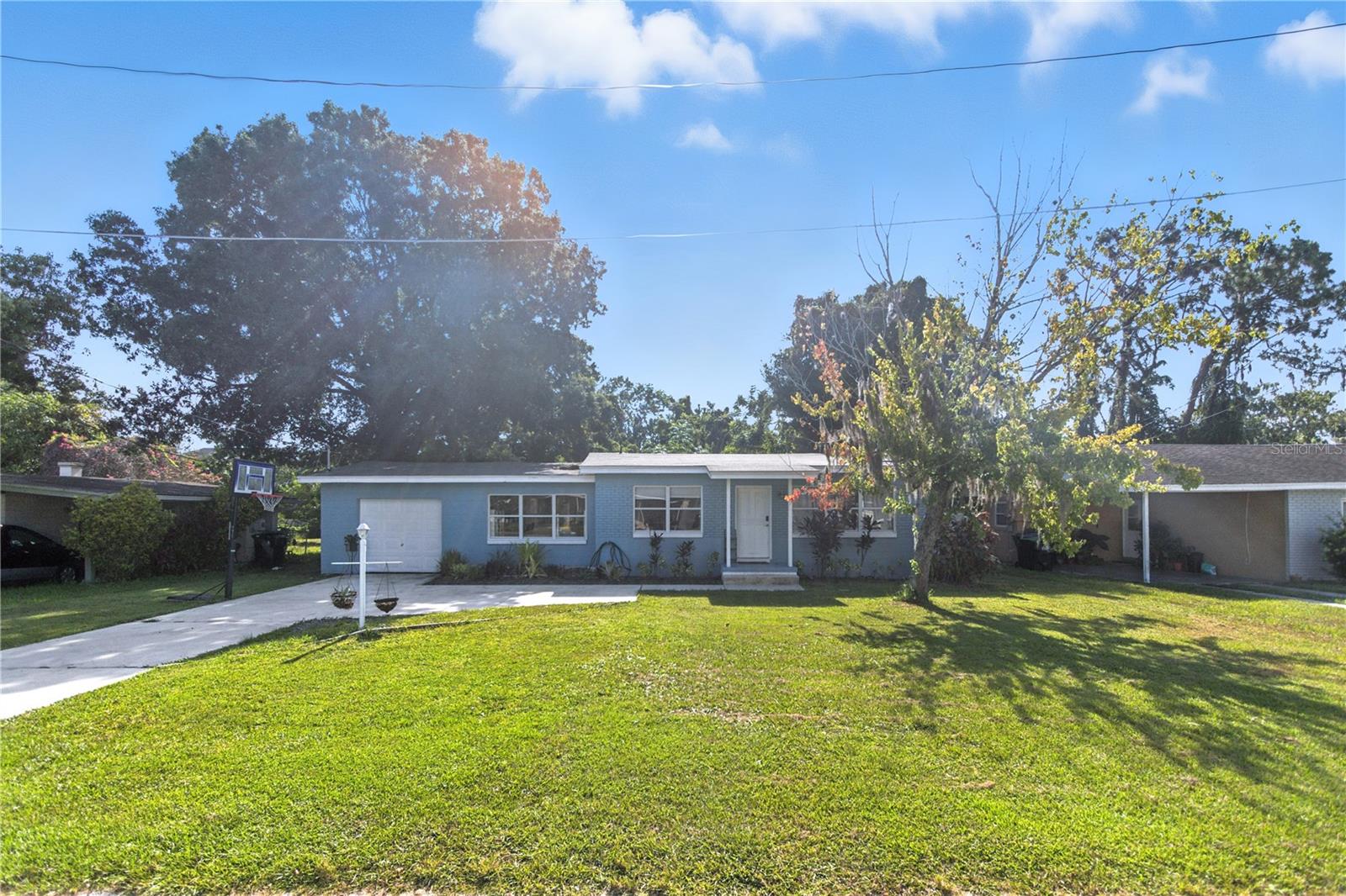 Welcome to 977 Pinelli Street in Orlando, Florida. This beautifully updated home offers peace of mind with a newer roof, a two-year-old AC system, a three-year-old water heater, and a brand new septic system. Enjoy a freshly paved driveway and a spacious lot with no rear neighbors, providing extra privacy and room to relax. The interior features an updated kitchen, modern flooring, and a renovated bathroom for a move-in-ready experience. The property also offers convenient access to a walking path, making it easy to enjoy outdoor activities while still providing the space and tranquility of a larger lot. Do not miss the opportunity to make this well-maintained and thoughtfully upgraded home in a highly desirable school district yours.