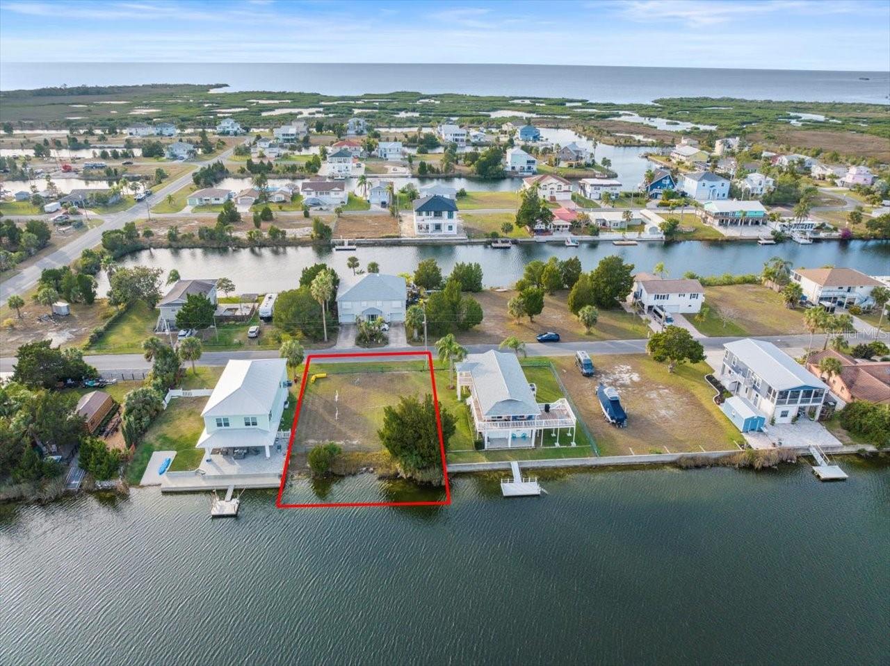 Vacant residential lot in the desirable coastal community of Hernando Beach. This 7,300 sq ft lot is one of the largest lots on one of the widest canals in the central section of Hernando Beach. This lot offers indirect Gulf access via a community boat lift, making it ideal for boating enthusiasts. Located on Florida's west coast, just 1 hour from Tampa International Airport, this property is perfect for a primary residence, vacation home, or investment build. No HOA and utilities available at the street for easy connection. The seller will install a fence to separate the lot from the adjacent home, providing privacy and a clear property boundary. Enjoy the peaceful, laid-back lifestyle of Hernando Beach with nearby restaurants, marinas, parks, and local attractions. Zoned for single-family residential use. Don't miss this opportunity to build your dream home in a quiet waterfront community with access to open water and all the Gulf Coast has to offer.
