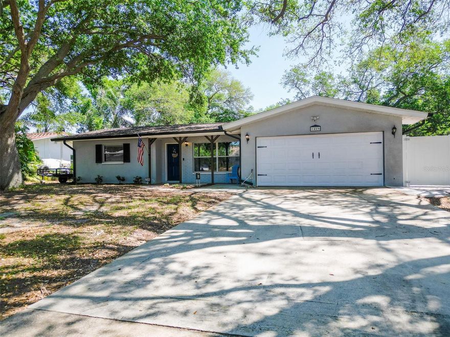Welcome to your Clearwater home that offers more space, more flexibility, and more functionality than you’d expect.  BONUS: NO Flood Zone!  From the moment you step inside, you’ll notice the flow—multiple living areas that give you options, whether you need a dedicated family room, second lounge, or space to spread out and actually live. Natural light comes through with updated windows, giving the home a bright, comfortable feel throughout.  The kitchen has been updated with solid cabinetry, granite countertops, and a clean backsplash, offering a functional layout with plenty of prep space and storage. Just off the kitchen, the laundry and utility area create a practical transition space connecting the garage to the rest of the home.  The layout includes three comfortable bedrooms with updated flooring throughout. The main bathroom features updated tile work, and a second full bathroom—located off the garage and laundry area—adds flexibility and convenience for guests, projects, or everyday use.Step out back and the home really opens up. A large wood deck extends your living space outdoors, giving you plenty of room to grill, entertain, or relax. Just beyond that, a built-out fire pit area with string lighting is already in place—creating a space that’s ready to be used from day one.  The backyard is fully fenced with white vinyl for privacy and low maintenance, and two storage sheds are included, offering extra room for tools, equipment, or storage. Mature trees provide shade and help define the space without taking away from usability.  And then there’s the garage.  More than just parking, this is a true workspace with additional power already in place, including 220V service, air line plumbing, and an updated electrical panel. Whether you’re into cars, tools, or need a functional work area, this setup delivers.  This home strikes a balance between updates and authenticity—move-in ready without feeling like an overdone flip—giving you the opportunity to enjoy it as-is or make it your own over time.  If you’ve been looking for a home with real functionality, flexible living space, and a garage that actually adds value… this is one worth seeing in person.  
Major Systems & Updates - 
Roof: Approx. 10 years old
HVAC: Approx. 8 years old
Water Heater: Approx. 1 year old
Electrical Panel: Updated in 2018
Windows: Hurricane-rated (updated)
Kitchen: Updated in 2018 (cabinets, counters, finishes)
Bathrooms: Updated in 2018
Flooring (bedrooms): Approx. 2 years old
Fence: Installed 2018, extended 2025
Deck: Built in 2020