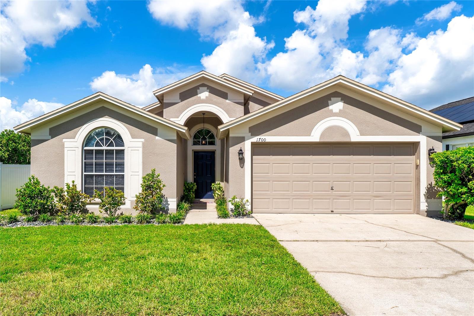Welcome to 1700 Leybourne Loop, a beautifully maintained 4-bedroom, 2-bathroom home nestled in the small, gated community of HEATHERSTONE in the highly desired MEADOW POINTE of Wesley Chapel. This spacious single-story residence offers 2,050 sq ft of thoughtfully designed living space with 10FT HIGH CEILINGS, abundant natural light, and a smart SPLIT FLOORPLAN- ideal for both comfort and functionality. Rest easy knowing all the major systems are new and ready to go! NEW ROOF (2024), NEW WATER HEATER (2024), HVAC System (2020). The main living areas feature durable and stylish engineered HARDWOOD FLOORING, while the bedrooms offer clean, well-maintained carpet. The kitchen is open and inviting with SOLID WOOD CABINETRY, STAINLESS STEEL APPLIANCES, GAS RANGE, and pantry. Just off the kitchen is a bright and open dining space with large windows and views of the backyard and patio. On the other side of the kitchen is a BONUS space perfect for a formal dining room, office, workout space, or play area for little ones. The primary suite includes dual closets and a recently updated ensuite bath featuring a frameless glass walk-in shower, a soaking tub, and a dual-sink vanity. French doors lead into the front bedroom, making it ideal for a home office, den, or guest space. Open up the large 3 panel sliding glass doors and enjoy a private SCREENED-IN BACK PATIO, overlooking a well-manicured fully fenced backyard with IRRIGATION SYSTEM with a beautiful water view of a peaceful pond and conservation area. Additional highlights include a full laundry room, a two-car garage, and fresh neutral finishes throughout. Meadow Pointe is known for its top-tier amenities including: a gorgeous RESORT-STYLE POOL, CLUBHOUSE, FITNESS CENTER, TENNIS, SHUFFLEBOARD, and BASKETBALL COURTS, PLAYGROUNDS, SPLASH ZONE for the kids, and scenic WALKING TRAILS- all with some of the LOWEST HOA's around. Conveniently located near TOP-RATED SCHOOLS, The Shops at Wiregrass, Shoppes at New Tampa, Tampa Premium Outlet Mall, lots of great dining spots, AdventHealth Wesley Chapel, I-75, and major highways for easy commuting.