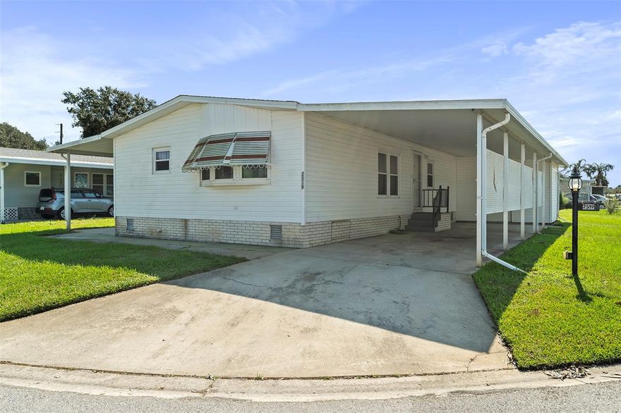 WHAT A GEM! Wait to see this Charming two bedrooms and two bathrooms in Active Adult Gated Community – Teka Village! Welcome to this lovely double-wide mobile home located in the desirable Teka Village, a gated 55+ community in St. Cloud, Florida, where the sunshine and warm weather make for a perfect retirement setting! This spacious 2-bedrooms, 2-bathrooms home offers comfortable living with an inviting lanai, ideal for dining outside or enjoying extra living space. Inside, you’ll find a well-appointed kitchen with ample cabinet space, along with a cozy living room and dining area. The owner’s suite offers a dual-sink vanity, a relaxing shower, and a separate tub, creating a personal retreat. The home also includes a full carport, providing convenience and protection for your vehicle. The vibrant Teka Village community offers a variety of amenities, including a clubhouse, recreation center, and a refreshing pool for residents to enjoy. With easy access to the Florida Turnpike, you’re just a short drive from Central Florida’s top attractions, Downtown Orlando, Lake Nona Medical City, and the Orlando International Airport. Additionally, St. Cloud boasts a charming downtown area with antique shops, craft stores, local diners, and historical landmarks like the American Legion Hall and VFW Hall. The Lakefront Park is a gem for outdoor enthusiasts, featuring walking trails, a splash pad, a boating basin, and more. It’s the perfect spot to take a leisurely evening stroll or bike ride while enjoying the stunning wildlife and lake views. Don’t miss this opportunity to enjoy the best of Florida living in this wonderful community! Call today for a private showing!