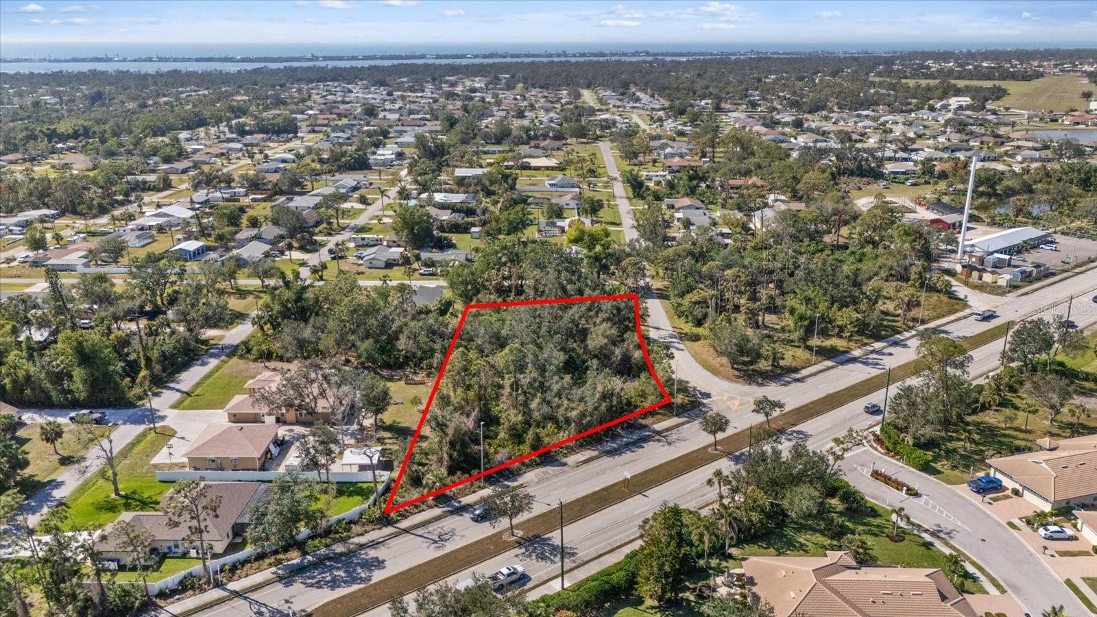 Oversized Corner Lot in Englewood, No HOA or CDD with Natural Gas This 0.79-acre (34,443 sq. ft.) lot in unincorporated Englewood offers a prime opportunity for investors, builders, or anyone looking to create a custom home. Located in the X500 flood zone, no flood insurance is required. The property features dual access from Gillespie Street and N. Indiana Avenue and is one of the few lots in the area with natural gas availability. This lot has the potential to be subdivided for two or three residences or developed into a single estate. This high and dry lot sits 13 feet above sea level and has access to city water and sewer. Located just eight minutes from the beach, walking distance to Buchan Airport, and close to shopping, golf courses, and restaurants. With no HOA restrictions, this is a rare opportunity to build without limitations. For more information, contact the listing agent today.