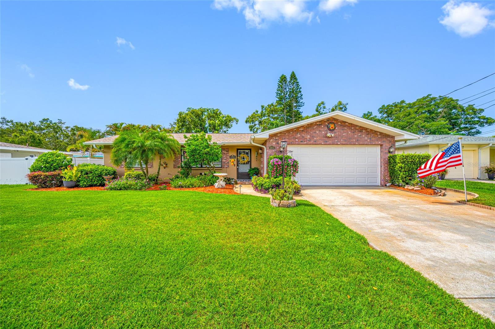 Looking for your Dream Home in the heart of Florida’s most beloved coastal town, then look no further. This attractive, 3-bedroom, 2-bath, split plan, pool home is just minutes from quaint downtown Dunedin. From the second you pull up you’ll notice the manicured lawn and beautiful landscaping that set the tone for what’s inside.
As you step inside, take in the view through the large picture windows overlooking the sparkling pool, fenced-in backyard with a fabulous garden that your neighbors will envy. The kitchen has just received a makeover with brand-new cabinets and countertops, and easy-care luxury vinyl floors which extend through the main living areas. Plantation shutters are installed throughout for an elegant feel.
But that’s just the start—there’s a new roof installed in March 2025, a new water softener (2025), attic insulation (2024), an updated HVAC from 2021, ductwork (2023), a water heater (2017), two new windows (2023), upgraded epoxy garage floor, and a Generac Power Inlet box for generator hookup. Plus, you get a six-zone irrigation system (2020) to keep all the landscaping looking great.
Out back, relax by your screened-in pool with a waterfall for that resort vibe, all surrounded by a garden that has been lovingly cared for through the years. You’ll be walking distance from the Dunedin Community and Fine Arts Center, with Downtown Dunedin, shopping, restaurants, and the Pinellas Trail all close by. And if you love the beach, Honeymoon Island State Park—famous for its gorgeous beaches and nature trails—is just a quick drive or bike ride away. This house really gives you a taste of everything that makes Dunedin such a special place to call home!