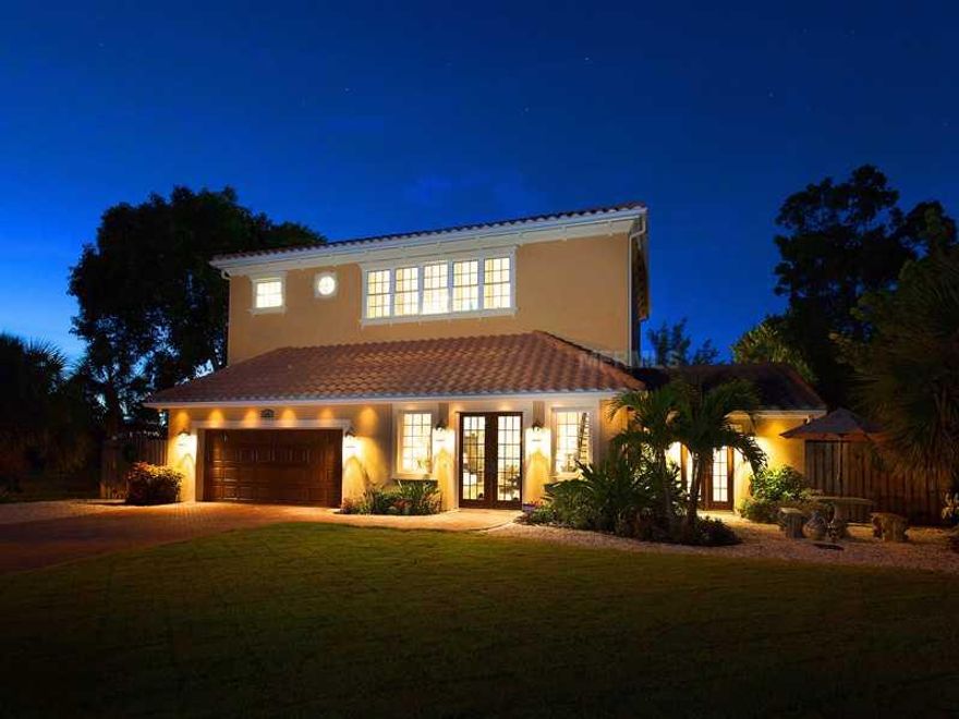 This home has been lovingly named Charity-Marie By the Sea. Enjoy your own private resort-style living on beautiful Anna Maria Island. Meticulously renovated in 2011, it surely will not disappoint. At every glance you will notice the attention to detail this lovely home offers. The chef's kitchen includes Kitchen Aid professional-grade appliances and a six-burner gas cooktop inlayed in a large granite island with wine fridge. An abundance of french doors throughout the home, with every bedroom having itsown entre to the outdoors, making each suite feel like a private oasis. Both indoor and outdoor dining areas have views of the expansive backyard with an oversized saline heated pool featuring a shallow water lounge and spa, either one perfect for relaxing while you admire your surroundings. Spend the day here in your private oasis or take your boat out that can be conveniently kept on your private dock equipped with a brand new lift. The famous white sand beach is only two-and-a-half blocks away. A custom iron and oak staircase leads to the grand second floor, offering soaring ceilings, two additional living areas, a spacious master suite, guest suite and large windows allowing light to flood in and warm your home. Extending the entire back length of thehome is an abundant second-floor terrace, approached through three separate sets of french doors and a winding iron staircase, where you can enjoy your beverage in the morning and the sunsets in the evening.