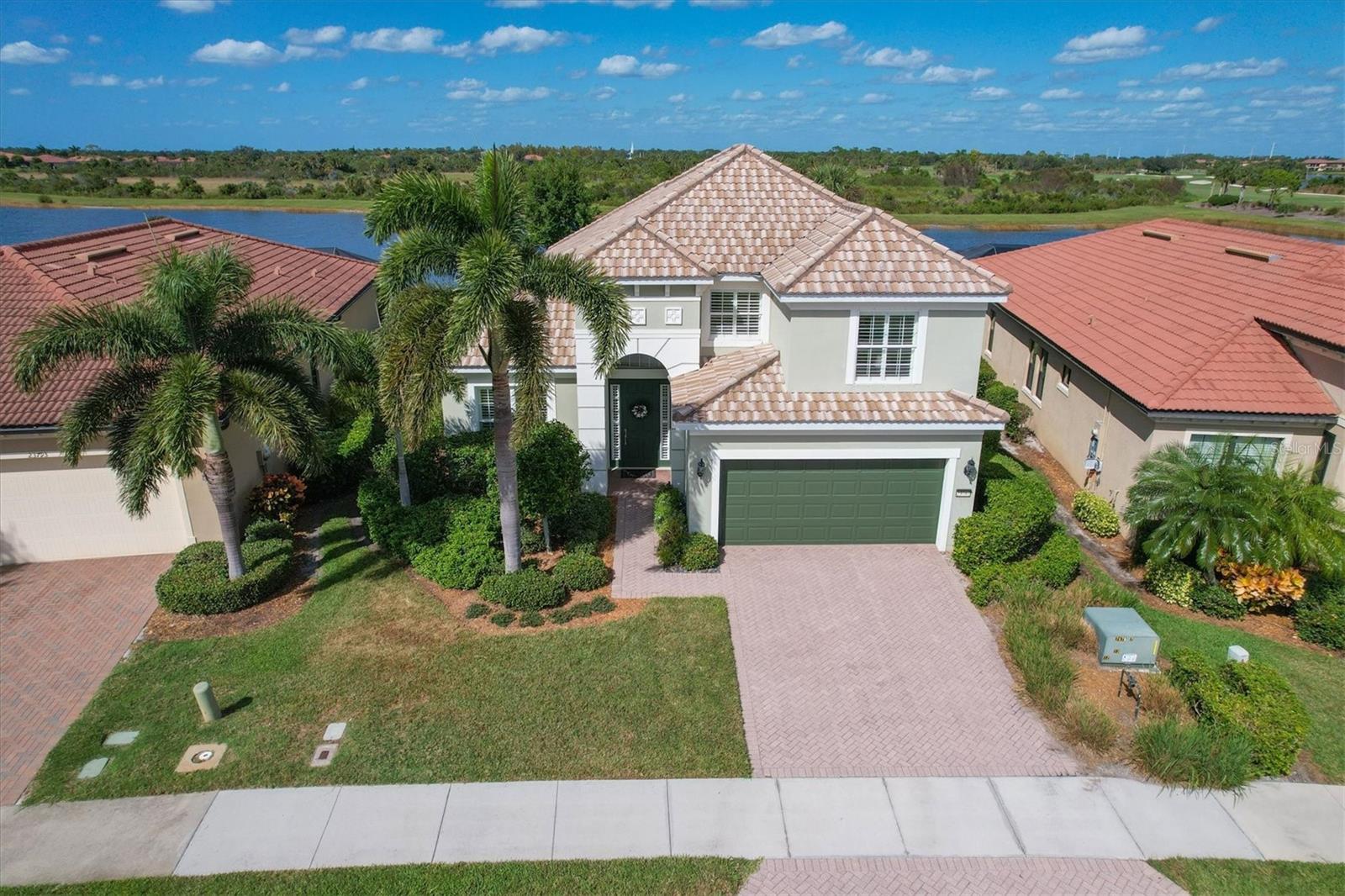 SPECTACULAR PANORAMIC LAKE AND PRESERVE VIEWS! SUNSET EXPOSURE! MUST SEE! Now is your chance to live on one of the best lots in Sarasota National. Sunset exposure with magnificent views. Your own private pool with water feature. NEW POOL HEATER 2022. Spacious lanai with outdoor kitchen. All the things that encompass the Florida Lifestyle. This floor plan offers 3BD/2.5BA/Den/Bonus area/2CG. Inside has been FRESHLY PAINTED. Spacious rooms and soaring high ceilings with transom windows letting in tons of natural light. Everything you need for everyday living on the first floor. Large living area with separate dining room directly off kitchen. Plenty of space in UPDATED kitchen with lots of cabinets and counter space. QUARTZ counters. Wood cabinetry. NEW STAINLESS STEEL BOSCH APPLIANCES 2021. Island for convenience of food prep offers extra storage along with big pantry. Breakfast nook overlooking the view with sliders to the lanai and the outdoor kitchen. ALL sliders out to the lanai pocket with is perfect for entertaining and gatherings allowing to mingle in and out. Separate Den/Office with french doors that offers quiet for those working at home or wanting to watch a different TV program. Master bedroom with en suite bath. Dual sinks, soaker tub, and walk in shower -ALL UPDATED. Also on the first floor you will find a half bath for your guest to use and big laundry room with cabinets, folding counter, and wash sink. Last but not least is access to 2 Car Garage. Tile floors throughout the first floor with exception of NEW CARPET OCT 2022 in Master Bedroom. On the 2nd floor you will find 2 guest bedrooms for family or guests with a master size bath offering his and hers areas with a walk in shower between. Upstairs also includes a bonus area that could be space for numerous things- another office/den, lounge space, workout space, or library with cushy window alcove perfect for curling up with a good book. The list goes on, what ever you can imagine or find need for. PLANTATION SHUTTERS ON WINDOWS. AC 2020. HURRICANE SHUTTERS. Sarasota National is a PREMIER community w/over 1300 acres designated for preservation, conservation, lakes, & open space w/ amazing views, Proclaimed as an Audubon International Certified Sanctuary, making it the most gorgeous & enjoyable golf course to play at in the area. Offering resort style amenities w/huge resort style pool & spa,Tiki Bar to serve refreshing drinks and a bite of lunch, tennis courts, pickle ball, Bocce courts, coffee lounge/library/card room/meeting place, 7000 sq ft fitness facilities offering classes & day spa, and a 30,000 sq ft Clubhouse w/dining and spectacular views. 18 Hole championship golf course surrounded by native wetlands and preserves provides an exhilarating & dramatic back drop for your golfing adventure. Minutes away from the new Wellen Park shopping area and Atlanta Braves stadium. Venice Beach & Venice Downtown are just a short drive. Your choice of restaurants & outdoor activities await. Come find YOUR Florida lifestyle TODAY and Live everyday like you are on vacation! MAKE YOUR APPOINTMENT TODAY!