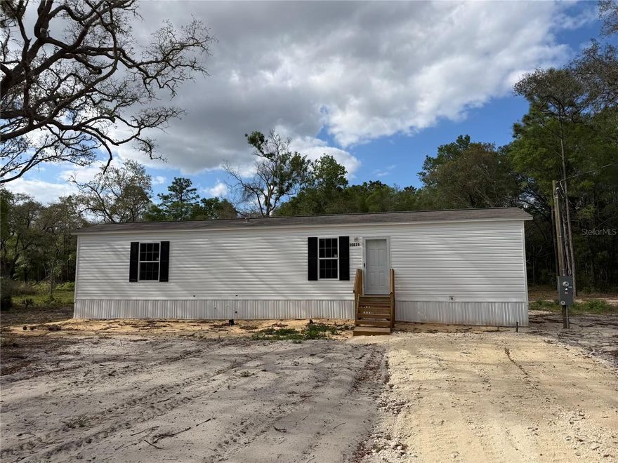 Welcome home to this adorable brand new Champion manufactured home, never lived in and ready for its first owners! Featuring 2 bedrooms and 2 bathrooms, this charming home offers a comfortable and efficient layout perfect for everyday living. Inside, you’ll find durable vinyl flooring throughout, providing a clean, modern look with easy maintenance. Situated on a spacious 1.25-acre lot in the University Estates subdivision in Bronson, the property offers a mostly cleared yard, giving you plenty of room to enjoy the outdoors, add a workshop, garden, or simply relax in your own private space. Enjoy the benefits of lower county taxes and utilities while still having plenty of space to spread out and create your ideal country retreat. Conveniently located just a short drive from Gainesville, you’ll have quick access to shopping, dining, and medical facilities while still enjoying the peaceful, quiet surroundings of rural living.