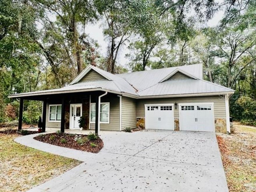 CUSTOM BUILT HOME WITH GREAT CRAFTSMANSHIP! This 3bd 2ba 2,022sqft home is located in RIVERWALK SUBDIVISION - GATED COMMUNITY! This property offers ample privacy, as it backs up to an untouched green space. Riverwalk is a nicely treed neighborhood with many community amenities, such as a pool, sauna, clubhouse, fitness center, nature, biking & walking trails, and tennis courts! This well-built 2006 home has 10ft ceilings, hardwood floors, stainless steel appliances, Corian countertops, a pantry in the kitchen, crown molding, decorative pendant lighting, an open floorplan, jetted tub in the master bathroom, and stone accents on the front of the home. Along with a 2-car attached garage with storage! Enjoy those cool evenings on either the covered front or back porch! Cypress details on the front porch! This beautiful home won't last long! Located in Gilchrist County with low property taxes and "A" rated schools. This home is less than 3 miles from the Suwannee River, Fort Fanning, and public boat ramps! Along with several local restaurants such as Suwannee Belle Landing, The Lighthouse, and The BBQ Shack. Call today to schedule your private showing!