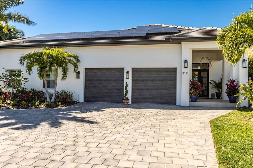 One or more photo(s) has been virtually staged. NEW PRICE ADJUSTMENT. The ultimate in coastal living! A fully renovated waterfront estate home with captivating water views of a protected cove and colorful sunsets daily! A prominent focal point is the spacious chef's kitchen, a culinary dream with top-of-the-line appliances, sleek stone countertops, a large center island, and a breakfast bar. The 900 sq ft covered lanai provides a lush outdoor entertainment area and private, additional living space with gentle cool gulf breezes wrapping around the property. The 160 feet of fenced seawall provides dolphin viewing access. Boating enthusiasts will delight in a private dock with a 16,000 lbs. boat lift, a floating dock for water sports, and additional mooring for a boat up to 50 ft. in length. Escape to the master bedroom suite featuring walk-in closets fit for royalty. King's closet (7x9). Queen's closet (14x15)! Fully renovated, well-appointed master bathroom with large shower and separate water closet.
Large private guestroom with adjacent full bathroom downstairs.  Additional upgrades include a walk-in wine cellar maintained at the perfect temperature by a Whisper-Kool system, Rinnai Tankless natural gas water heater and 22.2 KWH Solar Energy system installed July 2021 providing shelter from rising electricity costs. Many more additional features. If you are considering a waterfront lifestyle, this home is a must-see! Bedroom Closet Type: Walk-in Closet (Primary Bedroom).