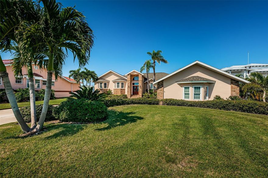 Rare opportunity in Bath Club Estates in North Redington Beach! Over 3,500 sq ft elevated home on a half acre of boating water, walking distance to the beach in sought after neighborhood of fine homes. The Open floorplan offers high ceilings, spacious rooms and wonderful water views! Designed around the tropical back yard for fabulous Florida entertaining, or just enjoying time with family and friends.
The generous 0.4975 acre waterfront lot offers 119.9 feet of water frontage on an exceptionally beautiful wide cove which opens to the bay. Truly a private oasis.
Leaded glass front doors open into a dramatic foyer and elegant great room with soaring ceilings and fabulous water views. The modern chef’s kitchen offers abundant well-designed storage, a gas range, granite countertops, a convenient island, and a sunny breakfast nook. The kitchen opens to a large family room, with vaulted ceilings, custom wet bar, gas fireplace, and windows & doors that bring the outdoors in and lead out to the large back patio.
All on one level, living spaces flow effortlessly from shared to private. With 4 roomy bedrooms and 3 baths, there is ample accomodation for family and friends.
The primary bedroom suite offers an extravagance of space. A bright and airy haven with vaulted ceilings, stunning water views and French doors leading to the terrace. The spa-like master bath has 2 vanities, a jetted tub, separate shower and two enormous walk-in closets.
All secondary bedrooms are bright and spacious, with plenty of closet space and an updated shared bathroom. The 4th bedroom is also well suited for use as an office.
An estate-sized back yard offers enjoyment for all! The inviting covered terrace allows year-round comfort with a shady
retreat to enjoy balmy beach breezes and sunset refreshments. Relax on breezy, sun-drenched afternoons in the sparkling bayside pool. Paver decking has all been recently replaced. The entire back yard features gorgeous tropical landscaping and enjoys magnificent sunsets.
Dock feautres deep, protected waterfront, power, fresh water, tie poles and a 10,000 lb wide-cradle boat lift. Hop on your
boat and be in the Intracoastal Waterway in minutes with direct access to the Gulf of Mexico and beyond. Entertain family and friends with sunny days, swimming in the pool, fishing off the dock, or drop in a kayak or paddle board and tour around the cove. A prime location to enjoy the unforgettable holiday Boat Parade - host a party to amaze your friends!
A large 3 car garage for your vehicles also offers additional storage.
Located on a quiet cul-de-sac in the friendly community of North Redington Beach just steps to the Town Park with tennis and pickle ball
courts, a playground, exercise equipment, paved walking paths and a picnic gazebo. A short stroll takes you to the sugar sand beaches and sensational sunsets over the Gulf of Mexico. Also close by are charming shops, restaurants and even a coffee shop! There is private resident parking at the beach access.
Constructed with a focus on quality and security, this block home is elevated to Flood Insurance Rate Map standards. New roof to be complete March 2024. Windows and doors have storm protections meeting current Miami Dade standards. The home has been meticulously maintained and updated with redesigned bathrooms and kitchen, updated electric, new generator, plumbing, HVAC, flooring, pool finish, paver decking, and more.