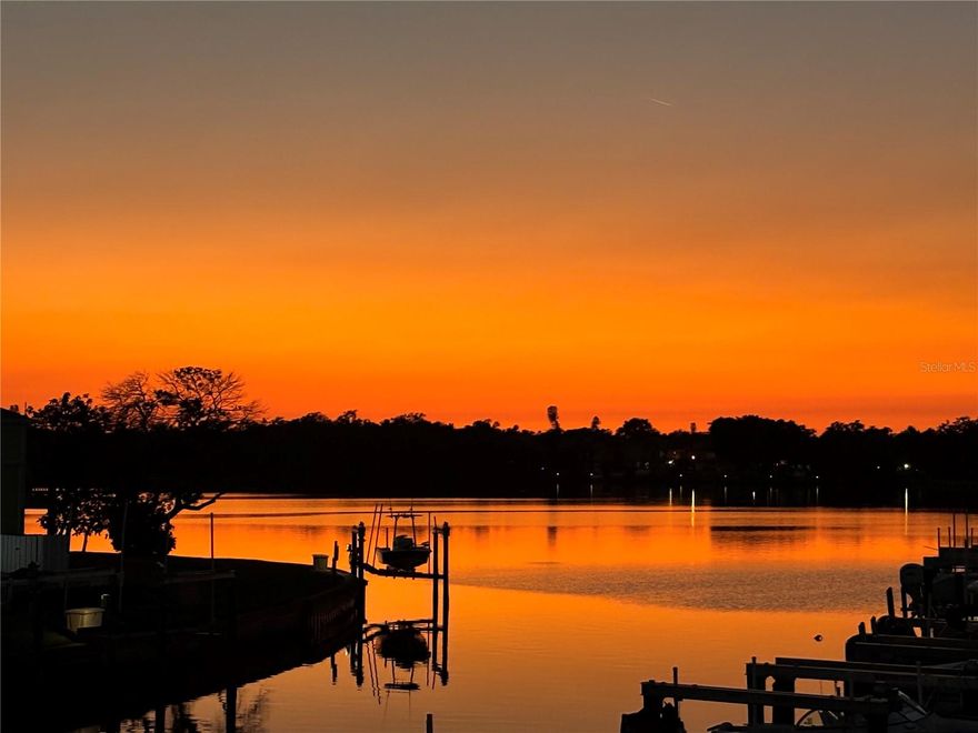 Waterfront sunsets and resort-style living await. This charming coastal two-bedroom, one-bath condo is turn-key and move-in ready.  It is located in the desirable gated community of Waterside at Coquina Key and boasts its own private balcony overlooking the magical evening sunsets over Little Bayou. This 733 square-foot condo is fully furnished with brand new coastal furnishings and features all new kitchen appliances, together with a new washer and dryer. Freshly painted and meticulously decorated, this condo creates the perfect backdrop for relaxing evenings and true coastal living. The French door leads onto a comfortable rear balcony located directly on the large canal with dockage and boardwalk within steps of your back patio.  The balcony offers panoramic views of the nearby waterfront and Little Bayou.   While this unit does not include a dock, dockage and boat lifts are available for rent and/or for sale right behind your condo and only steps from the rear balcony. This location offers easy and quick boating access to open water and Tampa Bay restaurants and nightlife. Waterside at Coquina Key South is known for its resort style amenities, including two large swimming pools, spa, and sauna, fitness center, tennis and pickleball courts, shuffleboard, kayak storage, boat trailer storage, and miles of scenic seawall walking paths across 88 acres of tropical waterfront paradise. Waterside is an active community with music and social events offered at the clubhouse, community pool and bar areas. Enjoy easy access to downtown St. Petersburg, beaches, dining, and entertainment, while coming home to a peaceful waterfront community.  HOA fees include guarded security, cable TV, pest control, water utilities, garbage, and recreational facilities, all of which add exceptional value and peace-of-mind.  Please contact Therese Pike (Owner/Broker) for additional details on this exceptional property.