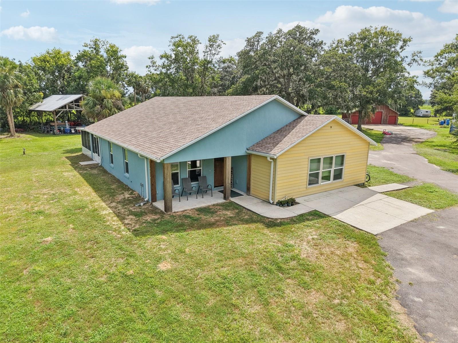 Private 5-Acre Retreat with Modern Home, Barns & More – Built in 2022!
Tucked away at the end of a secluded cul-de-sac, this stunning 5-acre fenced estate in Umatilla offers the perfect blend of privacy, functionality, and modern comfort. Behind the automatic gate, discover a beautifully built 2022 home with over 2,000 square feet of open living space, featuring 4 bedrooms and 2 baths.
Step inside to find high ceilings, crown molding, chair railing, LED can lighting, large ceiling fans, luxury vinyl flooring, and energy-efficient thermal pane windows throughout. The spacious great room flows seamlessly into the gourmet kitchen and dining area, where a massive 4'x13' quartz island with dual built-in charging stations steals the show. Enjoy top-tier stainless steel appliances including a Bosch double convection oven, a stainless farm sink, a walk-in pantry, closet pantry, and additional wall storage.
The bedroom layout offers a private primary suite with a classic tub/shower combo, while the light-filled second and third bedrooms provide plenty of space. The versatile fourth bedroom (or bonus room) measures an impressive 23'x19'.
Enjoy two screened porches (10'x25' and 9'x14') plus an open grilling porch—perfect for entertaining or relaxing outdoors. The property also features a 36'x32' pole barn, and an enclosed barn with 1,120 sq ft and a 20'x20' loft—ideal for an office, workshop, or vehicle storage—as well as a 10'x16' storage shed.
Additional highlights include a 50-gallon hybrid hot water heater, a 4” well with a 5-horsepower submersible pump, a whole-house Generac generator, and two propane tanks (250 & 125 gallons).
Conveniently located just off Hwy 439, this one-of-a-kind property offers space, seclusion, and all the modern amenities you need. Don’t miss this must-see home—schedule your private showing today!