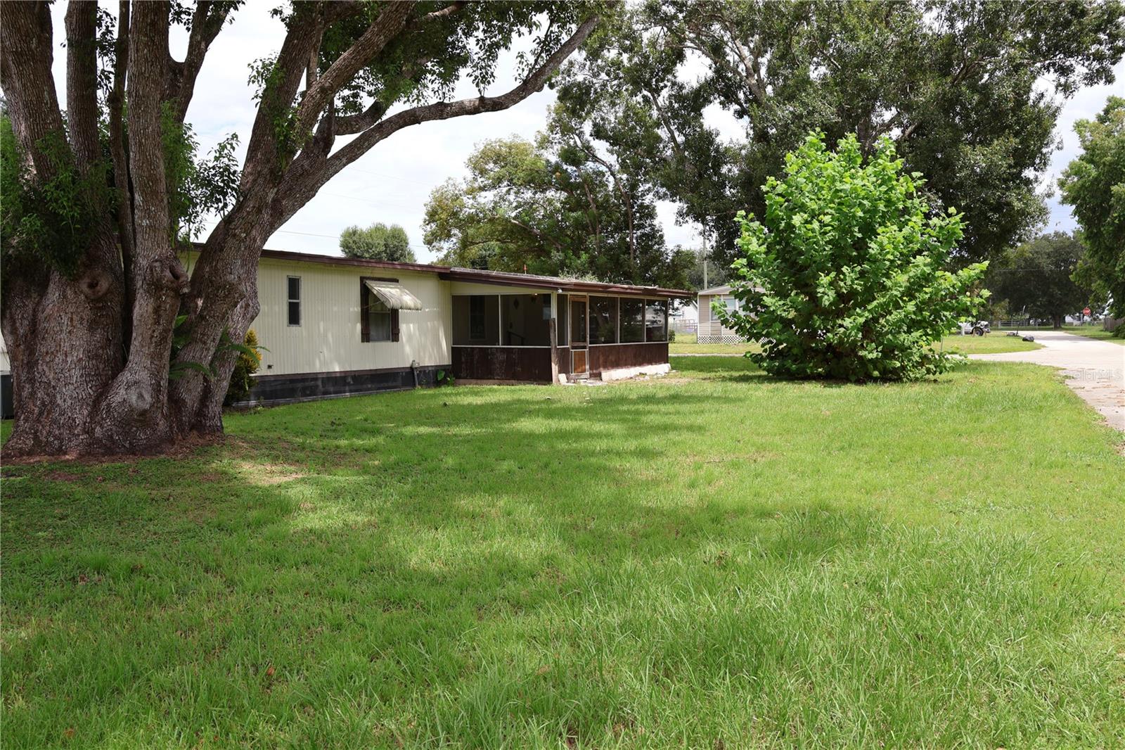 1983 manufactured home on a beautiful corner lot located in Charlie Creek Mobile Estates with NO HOA! Comes furnished with a handicap ramp from the carport. The .23-acre lot is owned (no lot rent) has a barn/workshop with concrete floors and plenty of covered extra storage on the side, has electricity with a new partial roof! Come see this cute and affordable home. Owner financing with 55% down, 4-year financing of the remainder @ 6.5% interest with quarterly payments of equal payments principal and interest. A first mortgage recorded on the property. Buyer will own the property.