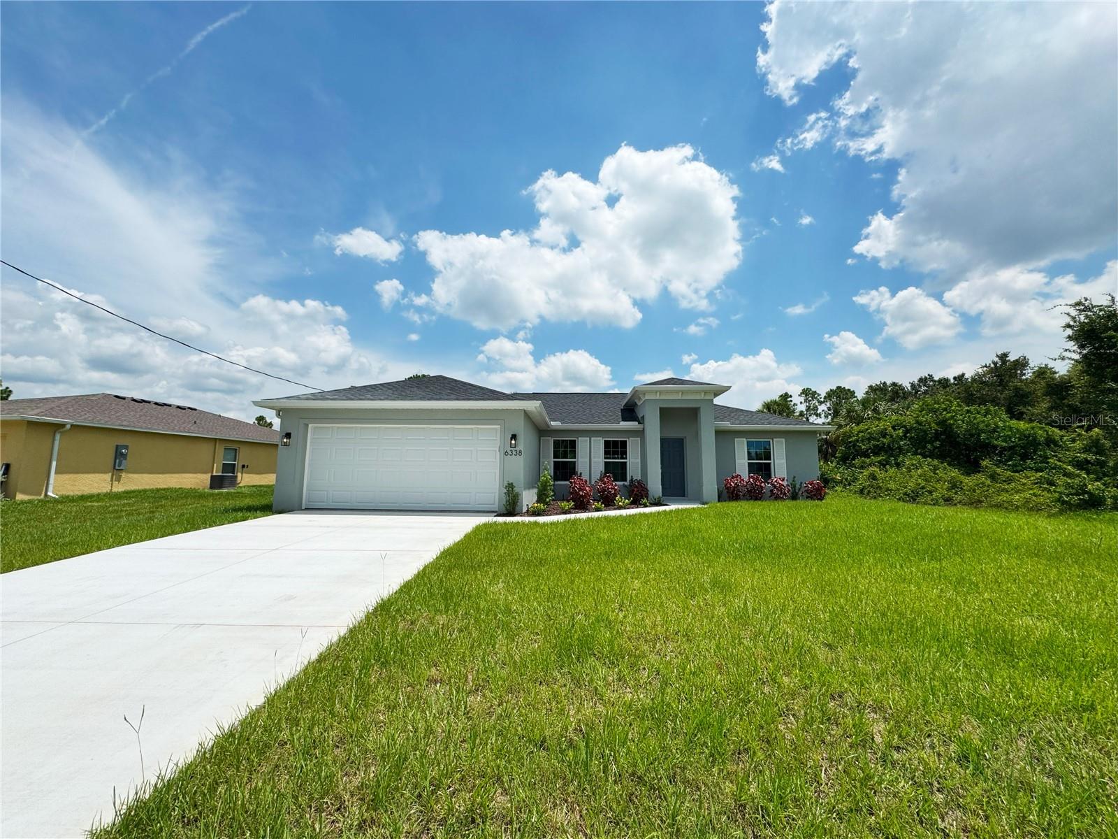 One or more photo(s) has been virtually staged. Beautiful New Construction Home Available Now! Everything is Included and Everything is Upgraded! Starting with an open, split floor plan with vaulted ceilings, this home has Hurricane Impact, insulated, low e windows, full overlay cabinets, stainless steel kitchen appliances, quality stone countertops and window sills, porcelain tile throughout, 30-year shingles, 3 zone sprinkler system, screened lanai, brand name plumbing and electrical fixtures, fully sodded and landscaped. This home has been built to keep insurance, maintenance and utility costs low. Preferred lender is offering up to $1,500 in closing cost assistance! Take a tour through of one of our Beautiful Homes: https://youtu.be/SFsL-Aell24