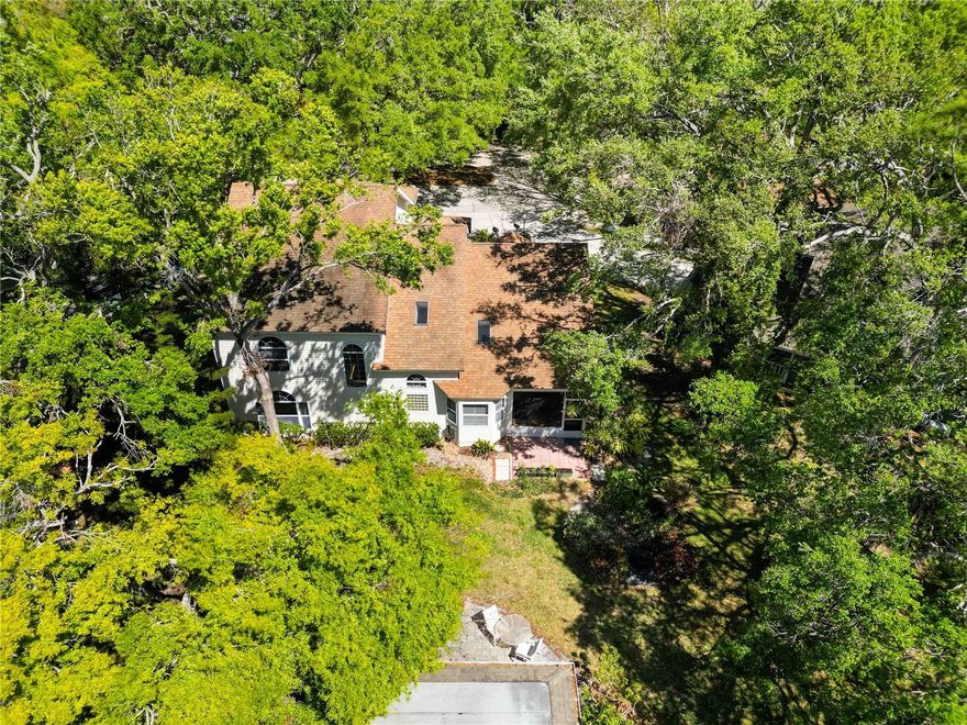 One or more photo(s) has been virtually staged. This charming two-story home offers over 3,000 square feet of living space in the quaint, tree-lined neighborhood of Arbor Oaks in West Bradenton.  Nestled in a cul de sac and surrounded by oak trees, this home provides a spacious and inviting floorplan featuring wood flooring throughout the large living space.  Soaring cathedral ceilings, plantation shutters, new paint and carpet in all bedrooms, and many windows and skylights letting in Florida's natural light help make this home unique.  The kitchen is very spacious with ample cabinetry and large island that is designed for easy hosting.  The loft space on the second floor adds an additional flex space along with the three upstairs bedrooms.  Even more, the community pool is just steps away from your screened lanai, so you have the convenience of a private pool in your backyard but without the extra maintenance.  Conveniently located near shopping, dining, and minutes from the stunning beaches of Anna Maria Island, put your personal touch on this house and call it 'home.'