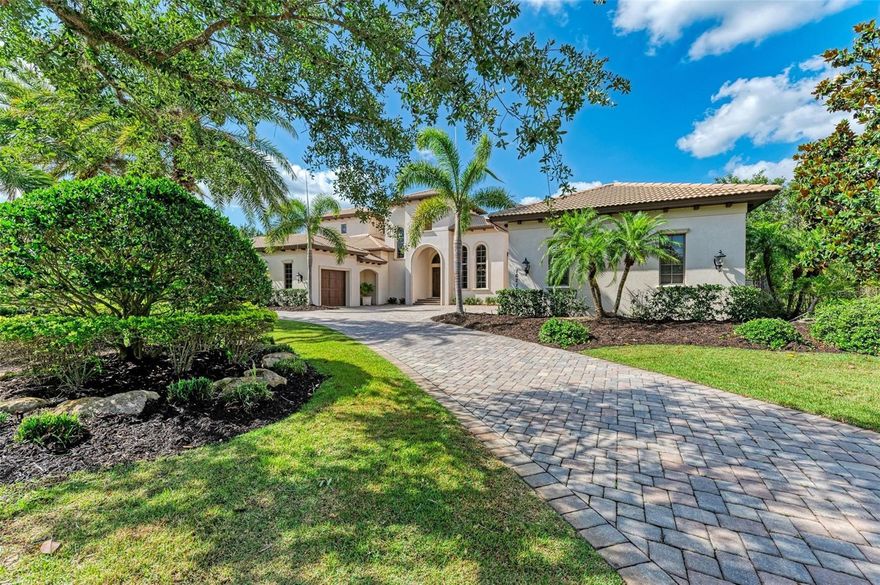 This magnificent estate home, constructed by John Cannon, is situated on nearly one acre of prime real estate in the Lake Club community. The breathtaking estuary views provide the perfect backdrop for relaxing evenings on the second level balcony. This home boasts timeless elegance and appointments that are unique to this coveted community, with Florida's natural beauty elegantly showcased throughout the spacious 5100 square foot interior, featuring travertine, wood, and carpet. The grand two-story foyer, complete with a stone-surround gas fireplace and sweeping staircase, anchors the grand room and seamlessly flows into the great room and gourmet kitchen. The kitchen is fully equipped with top-of-the-line Wolf and Sub-Zero appliances, a gas stove, wood cabinets, stone surfaces, an island, and a hidden walk-in pantry. The disappearing sliding doors lead to the outdoor oasis, featuring a pool, perfect for outdoor living. The master retreat includes a sitting area with lanai access and lake views, a luxurious en-suite bath, and custom-built walk-in closets that include a washer and dryer. The home also includes a cozy study, three en-suites, and a bonus area with a morning bar. Additional amenities include a four-car garage with ample storage, two dog runs, and an oversized laundry room. The Lake Club community offers a private lifestyle, including walking trails, tennis courts, resort-style pools, dining, and a fitness center. This home is ideally located near world-class golf courses, beaches, restaurants, shops, schools, medical facilities, and sports facilities. Recently updated with new AC, flooring, and pool heater, this home is move-in ready and exceeds all expectations.