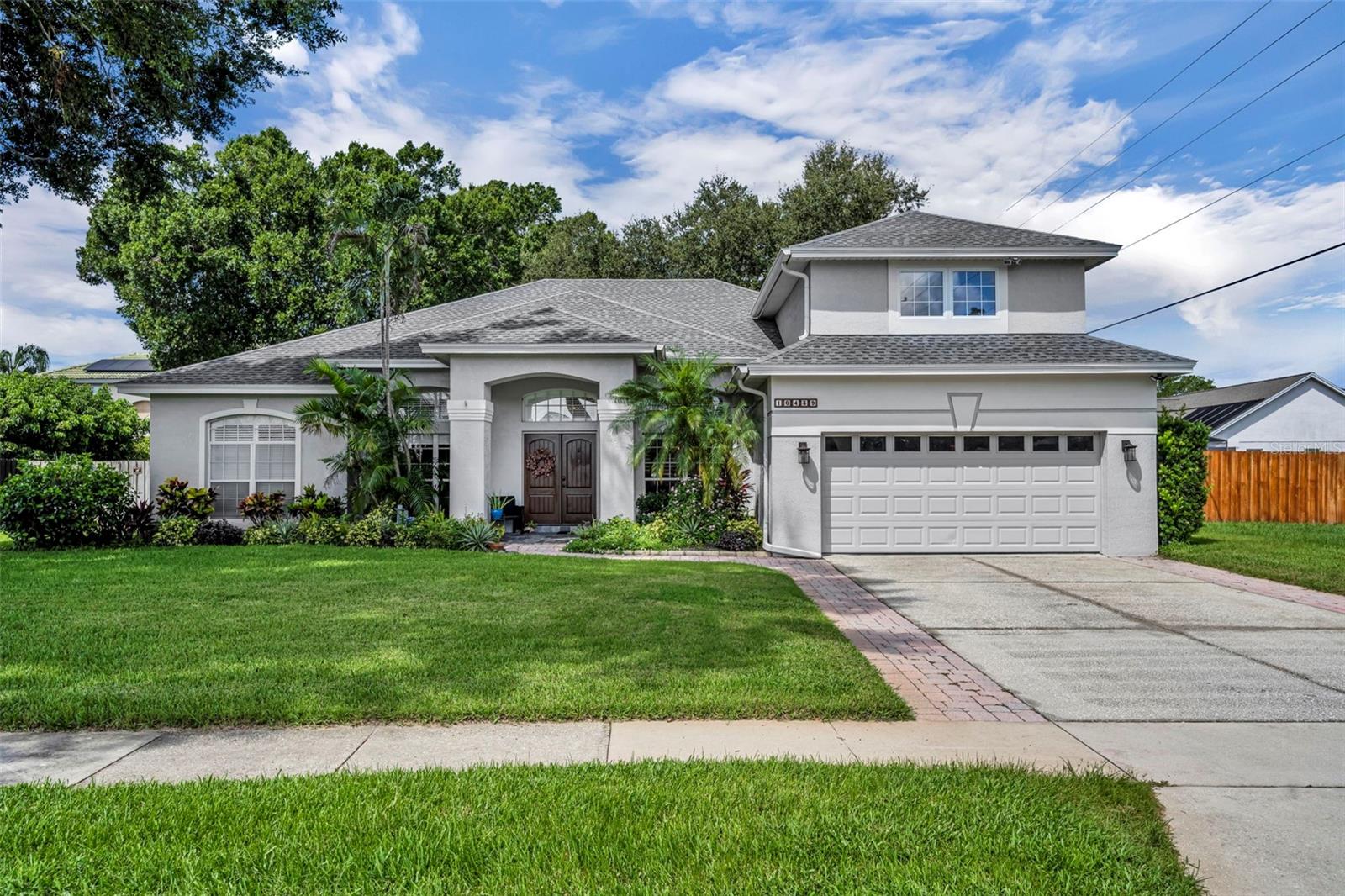 PRIME LOCATION with EXCEPTIONAL AMENITIES! This beautiful 4-bedroom, 4-bath residence with BONUS ROOM/GUEST SUITE is ideally situated on a spacious ¼+ acre lot. Designed with both comfort and functionality in mind, the home features an open, split floor plan, a generously sized kitchen, formal dining area, breakfast nook, and a FIRST FLOOR PRIMARY SUITE with direct access to the covered patio and SOLAR-HEATED, SALTWATER POOL. All bathrooms have been tastefully updated, and the oversized bonus room—with new luxury vinyl flooring and a full bath—offers remarkable flexibility. Perfect as a media room, game room, or private guest quarters, this space easily adapts to your lifestyle.The outdoor living area is a true retreat, complete with a fully fenced yard, an extended screened deck, hot tub, koi pond, and ample room for entertaining. A large storage room off the patio provides a perfect place to store the water toys. The community itself enhances the water enthusiasts lifestyle experience with a private boat ramp and dock accessing Big Sand Lake, an expansive recreational ski lake, along with two tennis courts, a tot lot, and a clubhouse. Additional home highlights include an oversized two-car garage with a Level 2 EV charger. Conveniently located, you’ll be just minutes from newly developed shopping centers, the new Lake Buena Vista High School, and, of course, the world-famous attractions of Walt Disney World. Roof 2020, NEW 2025 HEAT PUMP WATER HEATER, LOW HOA fees: $47/mo and Top Rated Schools. Don't miss out, schedule your viewing today!