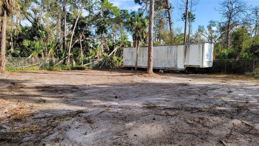 LAND FOR RENT WITH A 48’ STORAGE CONTAINER: Perfect secure site to store recreational vehicles, commercial equipment, outdoor supplies, trailers, machinery or belongings near the corner of US41 and Toledo Blade. Ideal location allows for fast access to Tamiami Trail and I-75. Entire 10,000 sq. ft. parcel is surrounded by a 6’ fence (privacy in front with chain link on sides/back) and accessible through a large 18’ wide roll gate. Included is a 48’ semi-trailer offering ample covered storage and protection from the weather. Cleared lot with plenty of space to utilize. Available for rent at $800 per month.