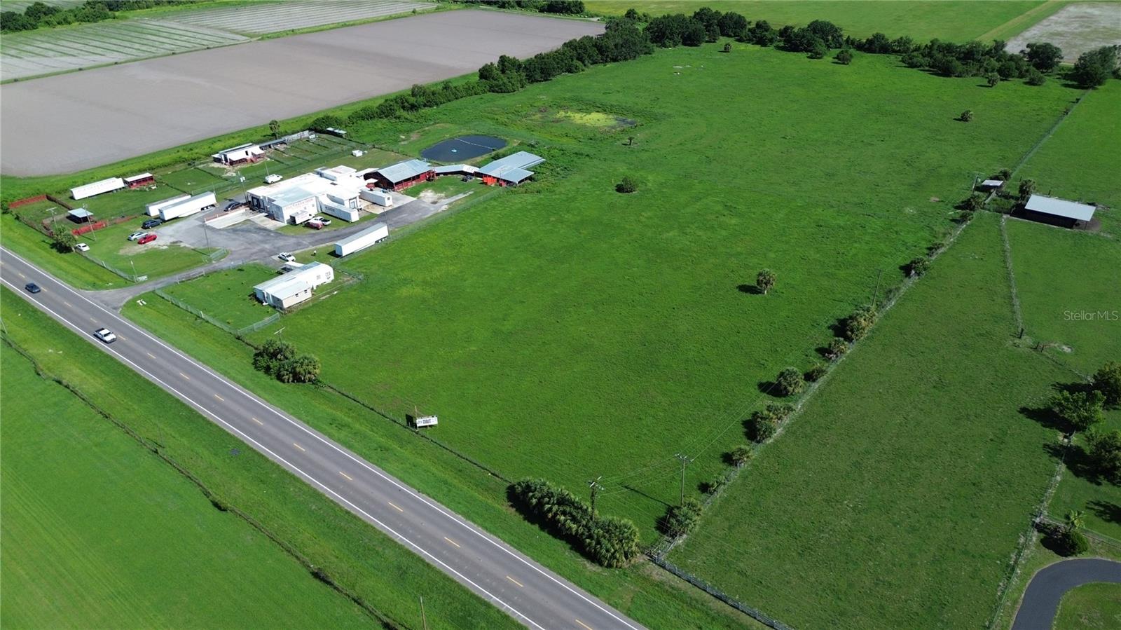 Prime 21-acre development site on SR 674 in Wimauma's Downtown East District. Zoned WVR-2 in the Urban Service Area with no commercial locational criteria, ideal for commercial, industrial, or mixed-use development. Eligible for TDR bonuses up to 4 DU/GA. Site includes gated access, existing infrastructure, fencing, and pond. Located in Hillsborough County’s designated growth corridor with prioritized utility expansion. Near US-301, Balm-Wimauma Rd, and CR-579. Excellent investment opportunity in the path of progress. The current use for the property is a meat processing plant that.