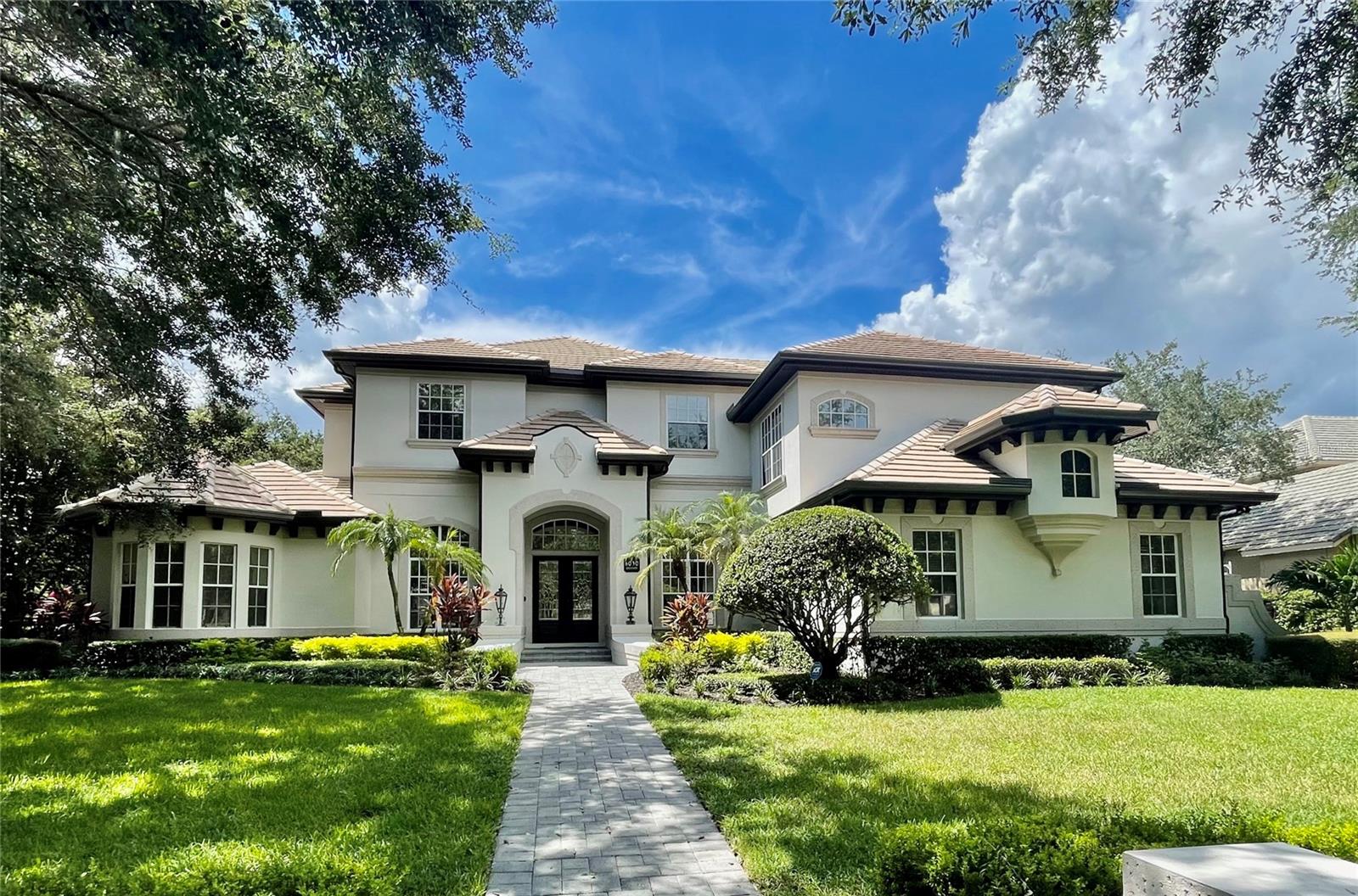 Remodeled turnkey home in the North Shore at Keene’s Pointe and situated on the desirable Greatwater Drive. The place to be, and the upscale location within the famed Golden Bear Golf Course at Keene’s Pointe. This home will exceed all expectations. Initially built by Richard Watson, has recently been remodeled entirely with exquisite transitional contemporary finishes. A Chef Inspired Kitchen with custom cabinets and natural stone counters, top of the line Wolf Appliances to include a 6-burner gas range, Wi-Fi enabled built in convection ovens, a double door Sub-Zero refrigerator, and more. Absolutely incredible lighting throughout. The layout is perfect for entertaining and the large windows allow for lots of natural light. The rear pool deck has been recently upgraded to include a putting green, and is the perfect spot to enjoy a hot Florida day followed by glowing sunset views across the Golf Course and Disney’s Fireworks in the evenings. The pool and spa have been beautifully crafted and the indoor and outdoor spaces naturally blend together. Newer HVAC units, Nest Thermostats, a new septic drain field, new SOD, new pool heater, updated summer kitchen, new water heaters, new built ins in all closets, new window film for comfort and energy savings, natural hard wood and natural stone all throughout, an integrated Sonos audio system all throughout the home, high end projection and audio equipment in the movie room, just to name a few. This home even has towel warmers in the bathrooms. Every aspect of this breathtaking home from the luxury master closet and dressing room, to the jaw dropping seamless glass reaching 11 feet high above the shower floor and Swarovski Crystal and Venetian Glass Chandeliers will impress even the most discerning of buyers.