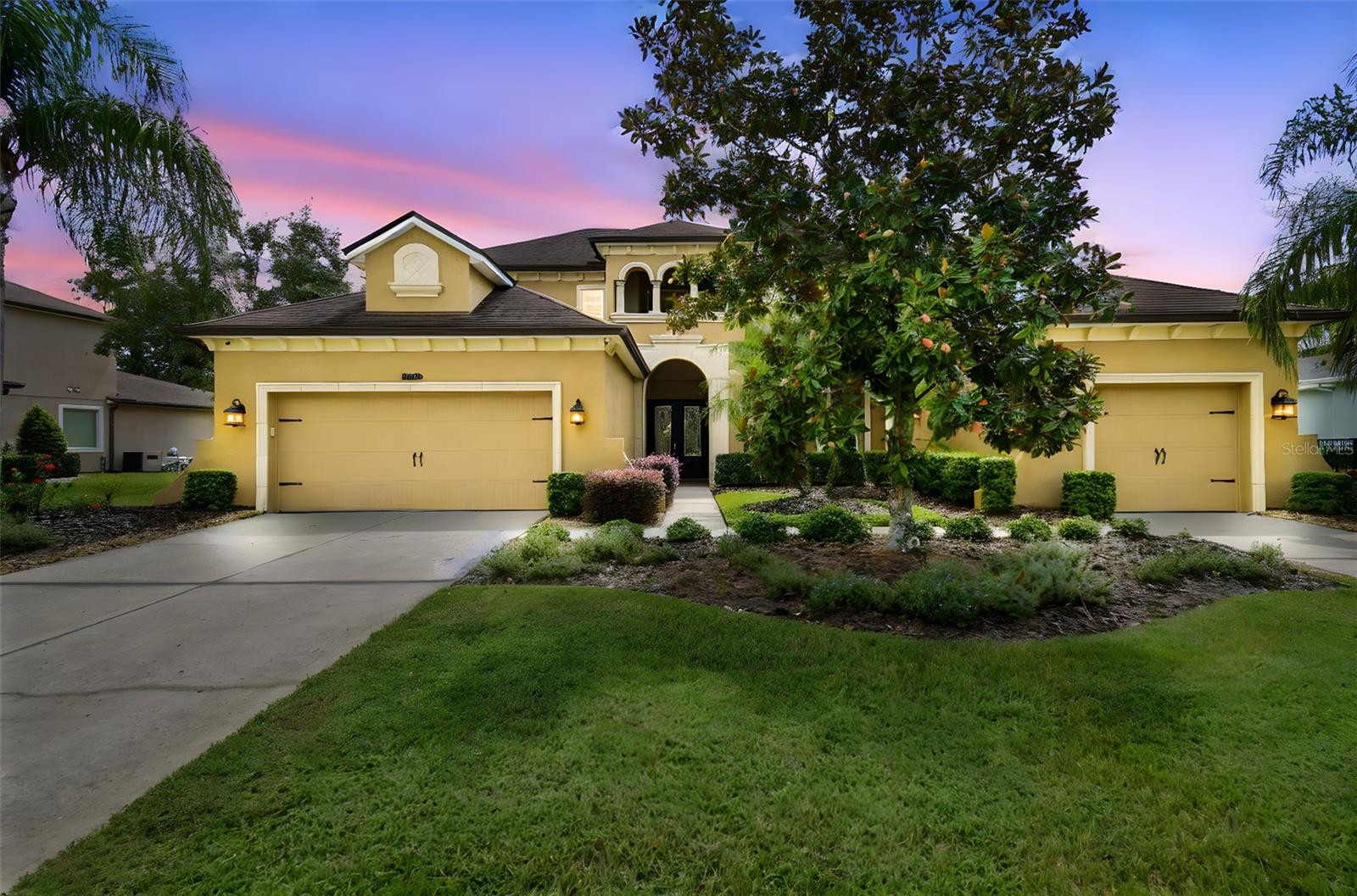 Seven Oaks. Gorgeous cul-de-sac home on magnificent conservation lot in gated Watermark, Seven Oaks most prestigious village. This 4 bedroom, 3 ½ bath, 2 car garage residence also has a loft, theater room, bonus room and an oversized, covered and screened lanai. The soaring ceilings provide for a very open feeling. The large kitchen with an island has upgraded stainless steel appliances, eat in area, walk-in pantry, overlooking the huge family room. The oversized first floor primary suite has views of conservation, dual sinks, walk-in closet, shower and separate tub. The family room is open to the second floor providing an abundance of natural light, and has two oversized bedrooms, one with access to large balcony, a bath with double sinks, a loft, theater and large bonus room. This home has many upgrades, including but not limited to guest bedroom on first floor, extensive wood floors, extensive plantation shutters, upgraded tile, large dining room & living room combination, screened travertine lanai with a half bath, split garages, sprinkler system, alarm system, gutters, acrylic coated garage floors, and a stately entrance with a front porch.