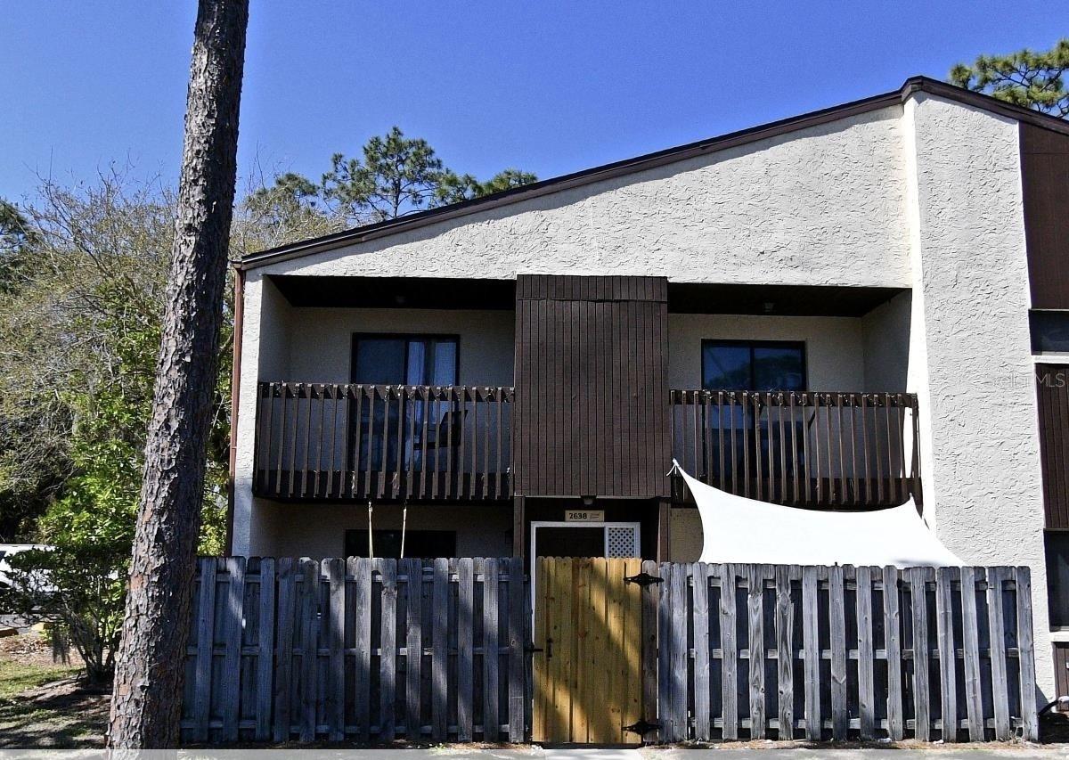 More pictures coming soon! Welcome to Windsor Pines Condominiums! This 2 story, corner unit condo has been remodeled and is the perfect location to call home if you're looking for a comfortable area that's close to everything. Enjoy 2 large bedrooms and 2 bathrooms! The first floor is completely tiled with a newly painted interior. Enjoy updated stainless steel appliances along with updated gray kitchen cabinets. Granite counter tops with a modern backsplash highlight the beautiful kitchen. This condo offers 2 separate sliding doors for easy access to the main entrance gated yard. Comes with updated washer & dryer. The AC has been replaced (July 2025). Roof will be replaced before closing. Updated carpet on the stairs and second floor. There's also 2 separate balcony's in the second floor so you'll have plenty of options to relax in the hot Florida sun. Amenities include a community pool and assigned parking. Don't let this beautiful affordable condo pass you by. Must see to appreciate.