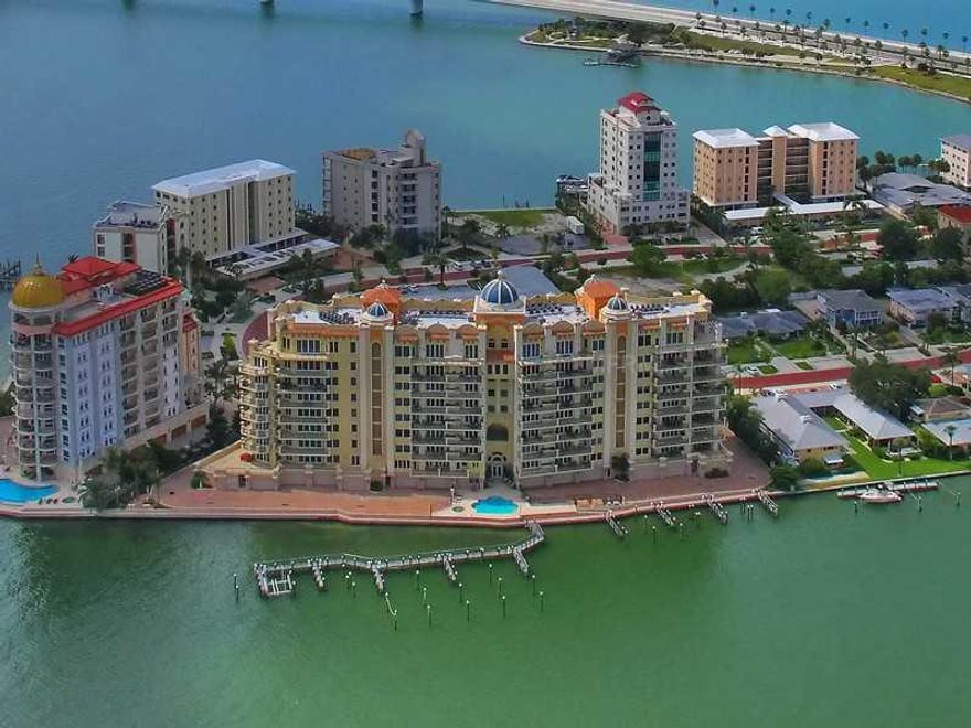 Savor the stunning views of downtown Sarasota, City Marina and the Sarasota Bay from this luxurious seventh floor residence at La Bellasara, one of Sarasota's premier addresses on Golden Gate Point. Private elevator foyer entrance, travertine flooring, high stepped ceilings, and detailed neutral finishes throughout. Wide hallways, multiple terraces, outdoor kitchen, two private en-suite guest rooms, and spacious built-in office with French glass paneled doors. The kitchen, complete with commercial grade six burner gas cooktop, Sub-Zero refrigerator, island with separate sink, custom wood cabinetry, granite countertops, and large breakfast area, is perfect for entertaining or for casual family dinner. A separate dining area provides ample space for more formal entertaining. Spacious master wing features double door entry, morning bar, two separate bathrooms with walk-in closets, and extensive terrace capturing both the cityscape and waterfront views of Sarasota. Private two-car garage conveniently located immediately adjacent to the ground floor elevator entry. La Bellasara features full concierge service, harbor side pool area, fitness room, theatre, and billiard room with a bay front terrace. Furnishings are available for separate purchase.