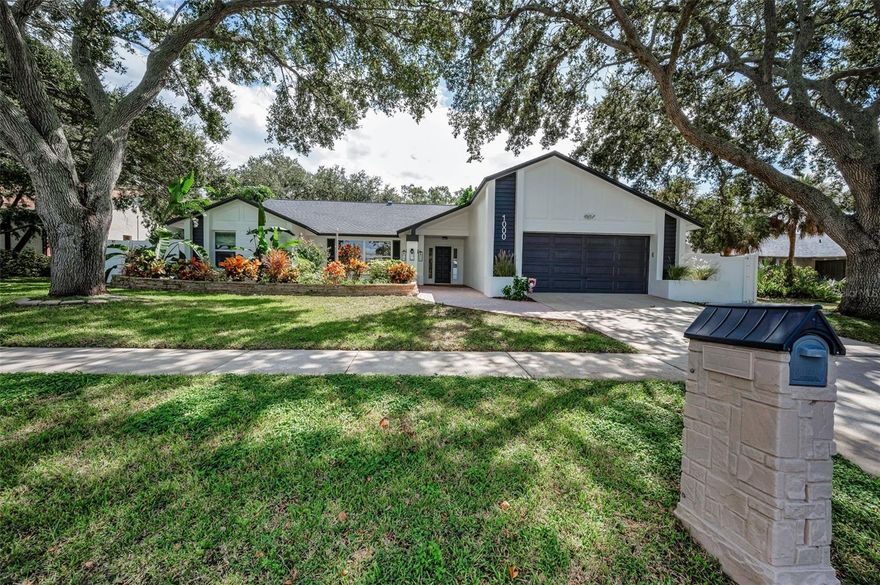 Auction Property. AUCTION! Sold free and clear of all liens. Listing price is the opening bid. Auction held live on site at the house SAT OCT 25th at 12pm. Welcome to this beautifully remodeled 3-bedroom, 2-bathroom pool home located in the highly desirable community of Wexford Leas in Palm Harbor. Nestled on a quiet street with stunning mature landscaping and a true Florida feel, this move-in ready home offers modern upgrades, stylish finishes, and the kind of outdoor living space that makes every day feel like a vacation. Step inside to find an open-concept living and dining area with soaring ceilings, brand new luxury vinyl plank flooring, fresh interior paint, and designer lighting throughout. The kitchen features stainless steel appliances, and a large breakfast bar perfect for casual dining or entertaining. The split-bedroom layout provides privacy, with a spacious primary suite that includes a walk-in closet, an en-suite bath complete with a separate shower and a large tub. The two additional bedrooms are generously sized. Step outside through sliding glass doors to your private backyard oasis, featuring a screened-in pool with a large covered patio—ideal for relaxing, grilling, or hosting guests year-round. The fully fenced yard offers both privacy and space to play or garden. Other exterior features include a brand new roof, gorgeous landscaping and fresh paint. A clean 4pt inspection is available. Zoned for A rated Palm Harbor schools. Located just minutes from the Dunedin Causeway, Honeymoon Island, beaches, shopping, dining, parks, and with easy access to US-19, this home combines comfort, convenience, and coastal Florida living at its best in a Non flood zone.