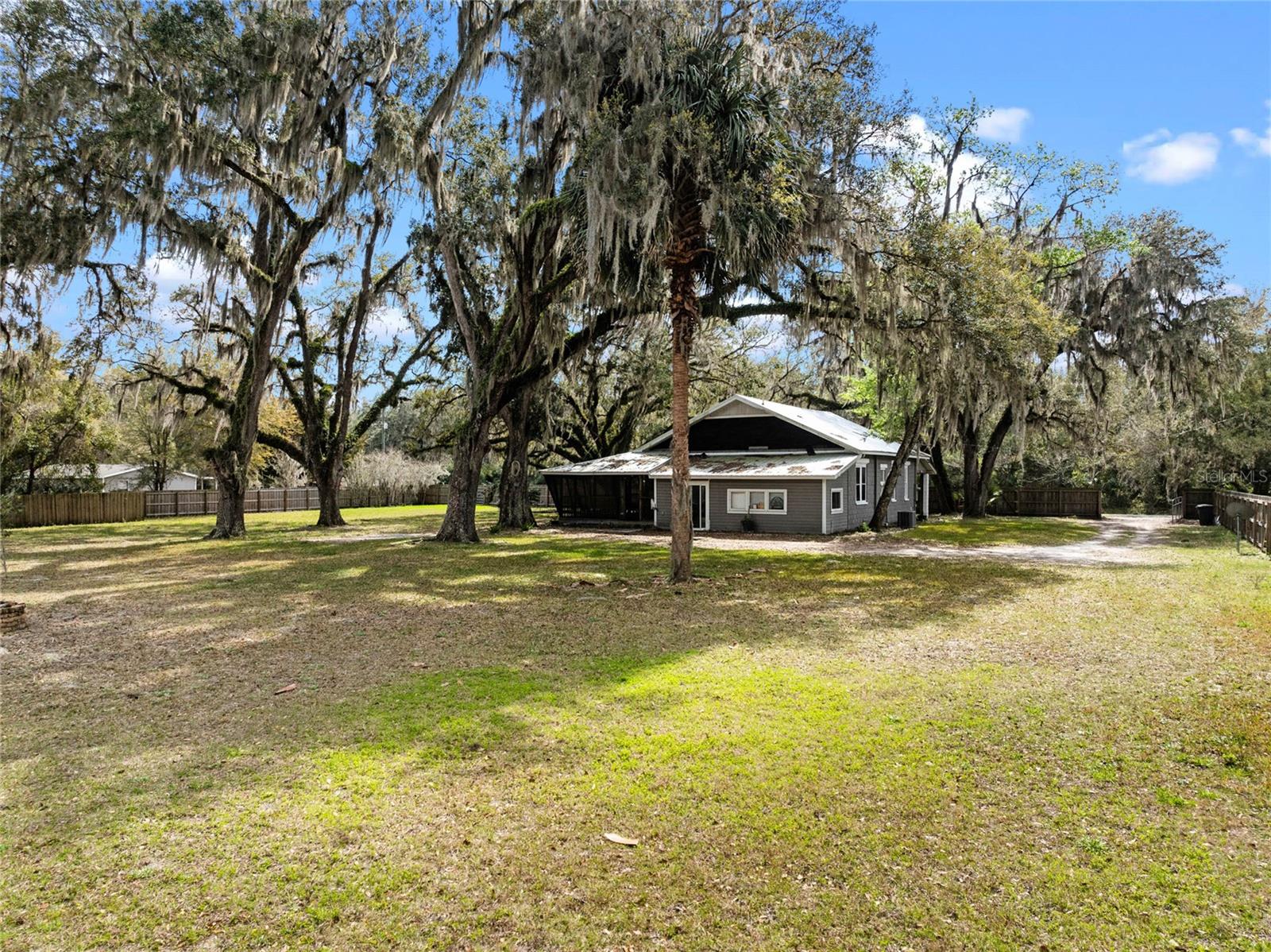 Seller will contribute $5000 towards closing costs! Set on over an acre of peaceful land, this cozy 3-bedroom, 2-bath home offers the perfect mix of charm and comfort. Inside, you'll find original wood floors that give the home a warm, inviting feel. The spacious kitchen has plenty of cabinets and counter space, making it a great spot for meal prep or hosting friends and family. There's also a bonus room that can be used however you need, whether as a home office, playroom, or craft space. The Florida room is filled with natural light and offers lovely views of your private yard.
The primary bedroom is a true retreat with its own bathroom and a big walk-in closet. The laundry room is conveniently located with extra space for storage. The home also has a sturdy metal roof, a screened-in porch for relaxing, and a fully fenced backyard surrounded by beautiful, mature oak trees, perfect for outdoor gatherings, pets, or just enjoying some peace and quiet.
You'll love the additional features like the RV carport, ideal for storing your RV or other outdoor equipment, and the wide open space that can be used for gardening or whatever your heart desires. The entire property is fenced, giving you complete privacy to enjoy your time outdoors.
This home offers a quiet, private retreat in Hawthorne, but still close enough to everything you need. It's a rare find, and we'd love for you to come see it in person. Reach out today to schedule a showing!