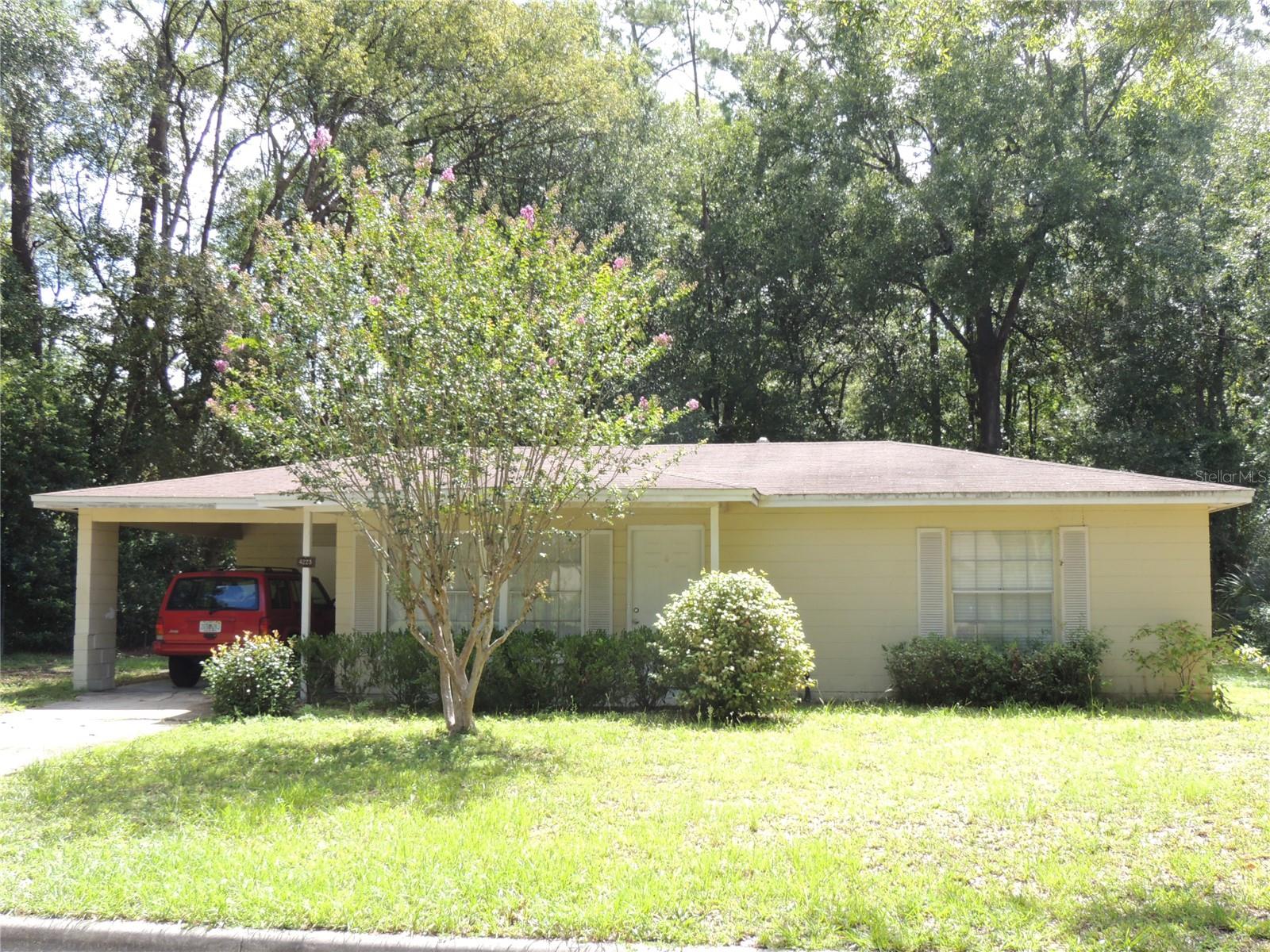 Charming 2 bedroom 1 bath block home on large lot in close proximity to NW Gainesville shopping & schools. The partially fenced back yard allows plenty of room for projects or entertaining. Large utility/laundry room off the 1 car carport with ample storage space.